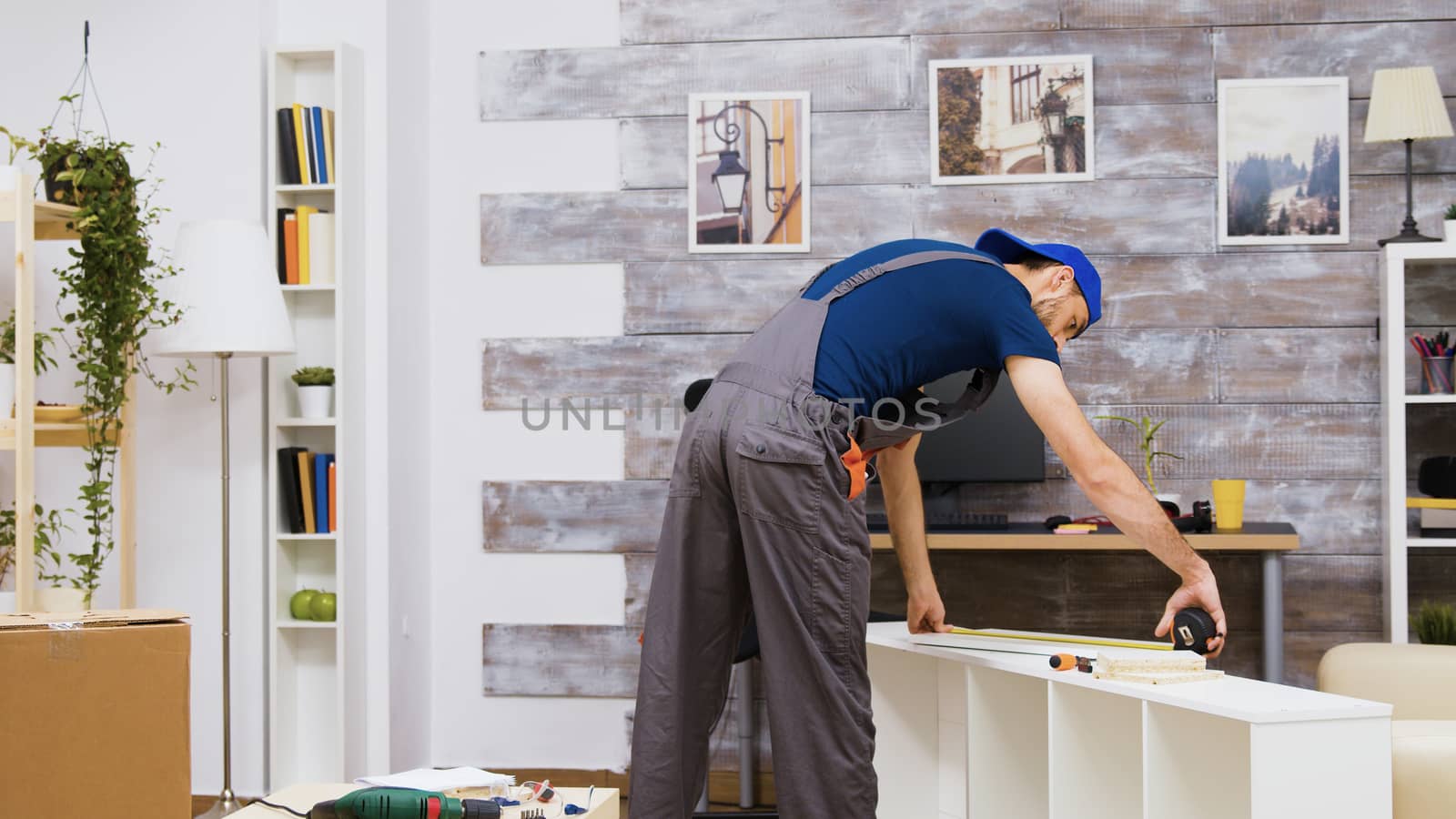 Furniture assembly worker standing reading instruction by DCStudio