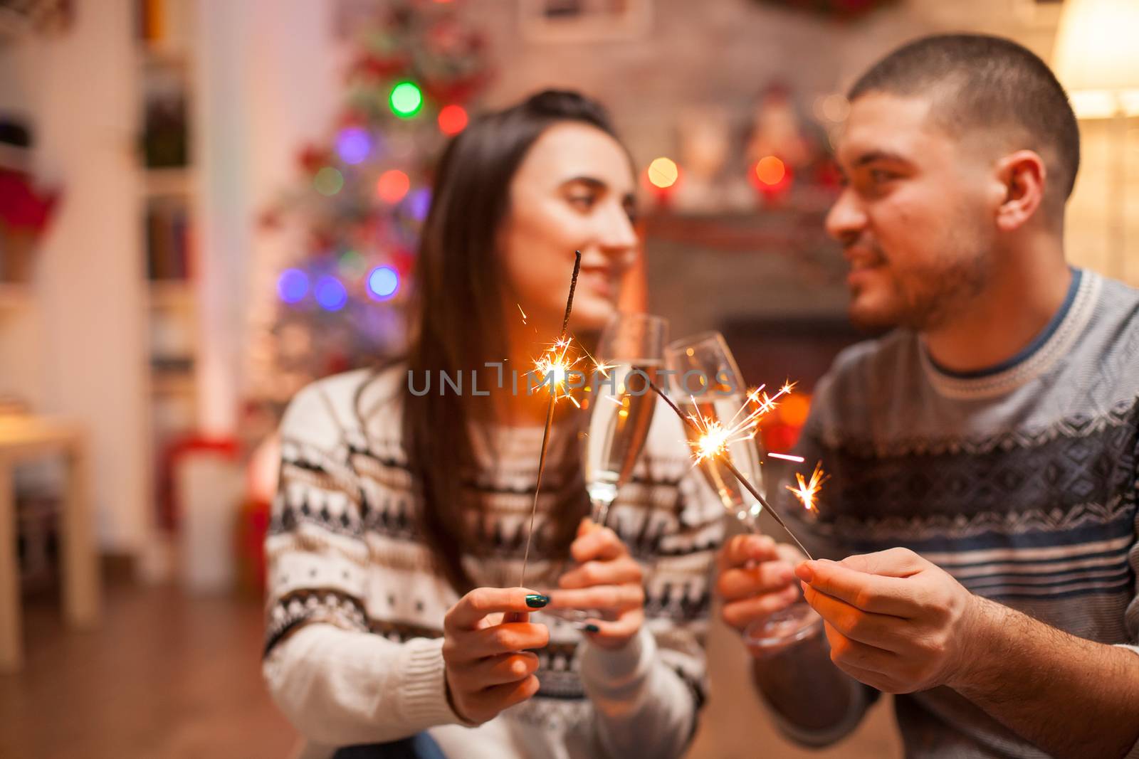 Loving couple with hand fireworks flicker brightly by DCStudio