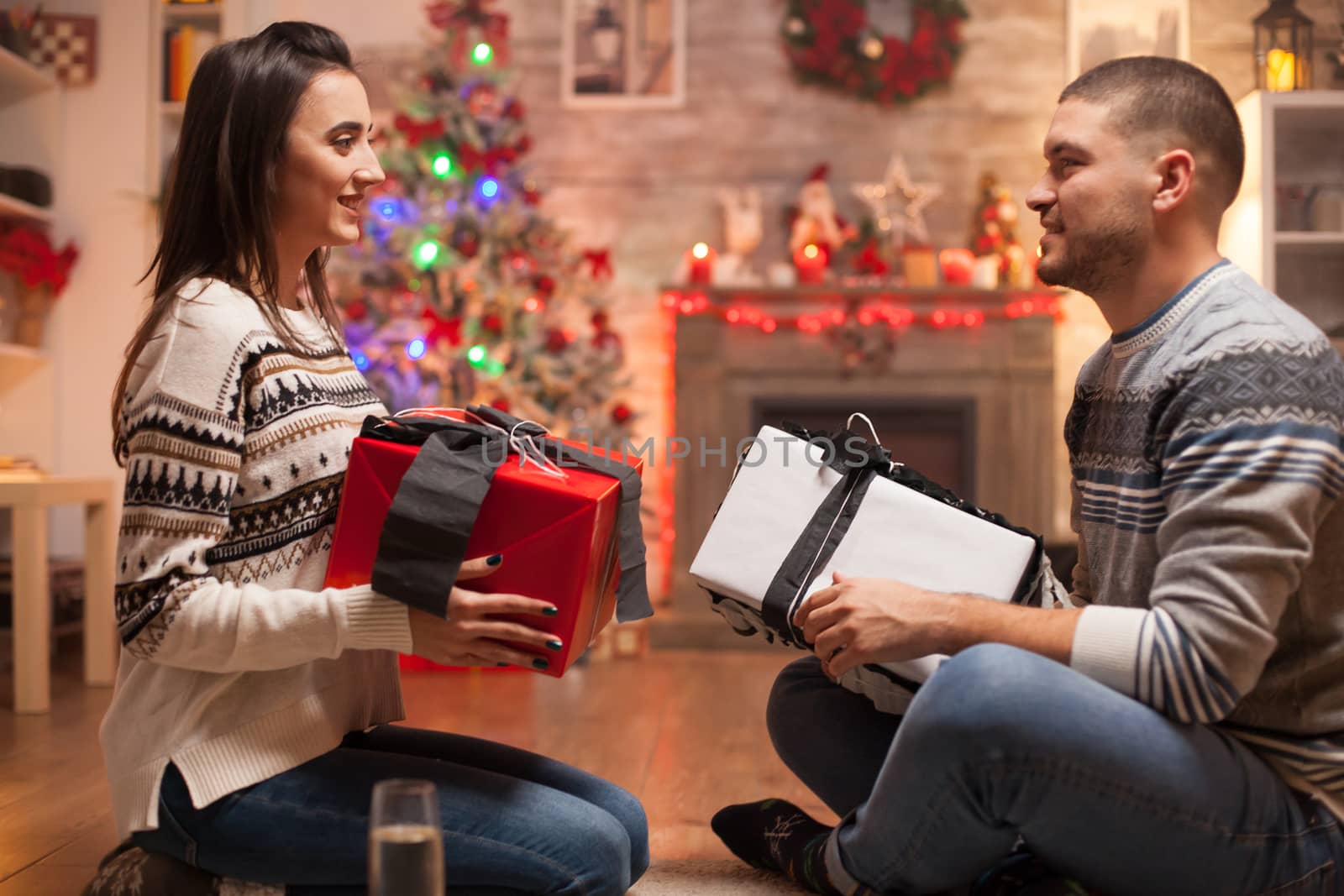 Happy girlfriend and boyfriend on christmas day by DCStudio