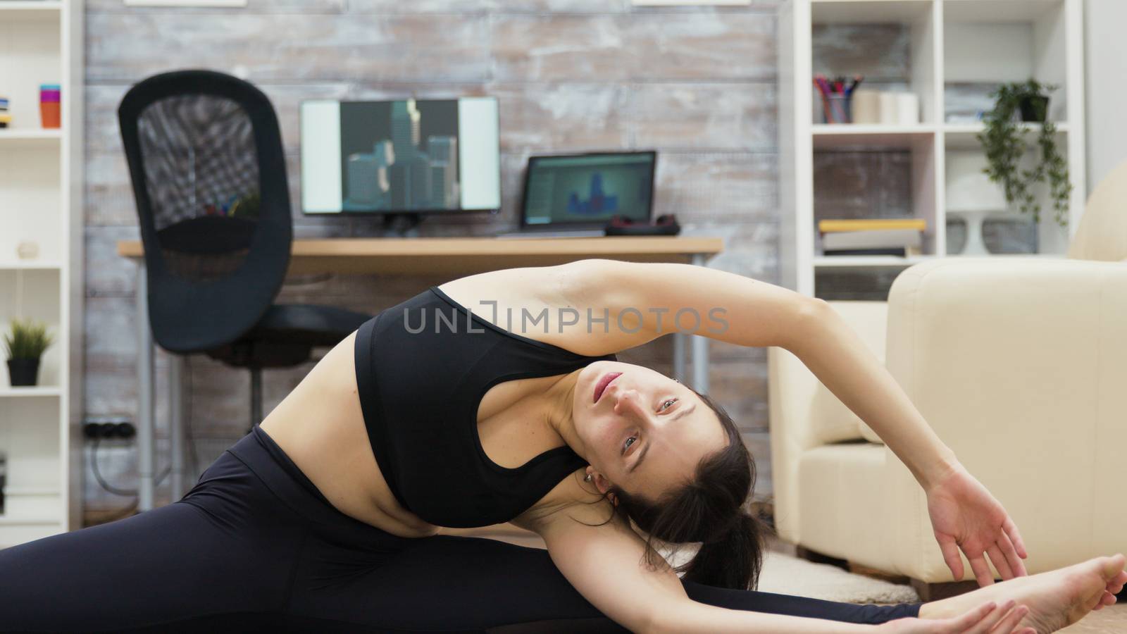 Calm and healthy young woman practicing yoga by DCStudio