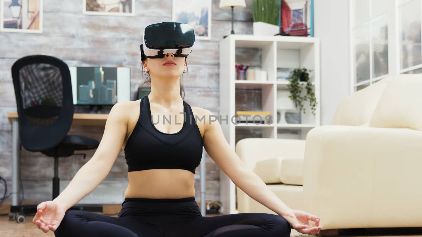 Caucasian woman doing yoga relaxation with virtual reality glasses sitting on mat in living room.