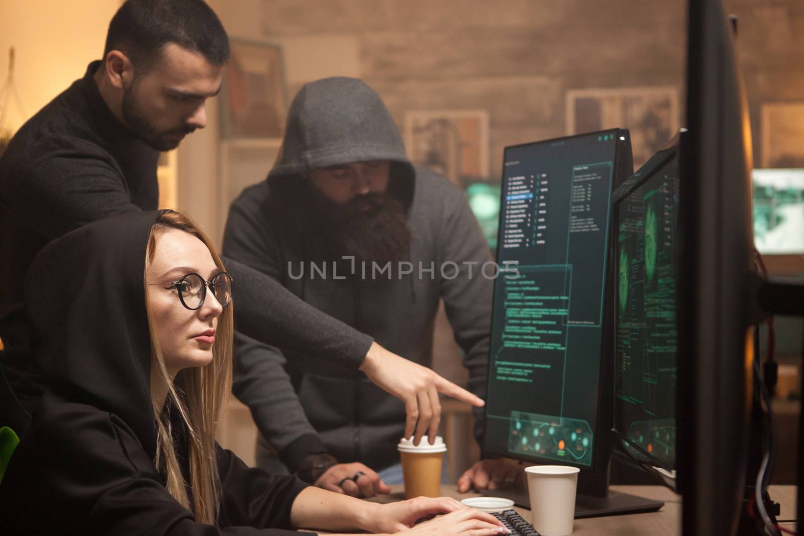 Young hacker working together with cyber terrorists by DCStudio