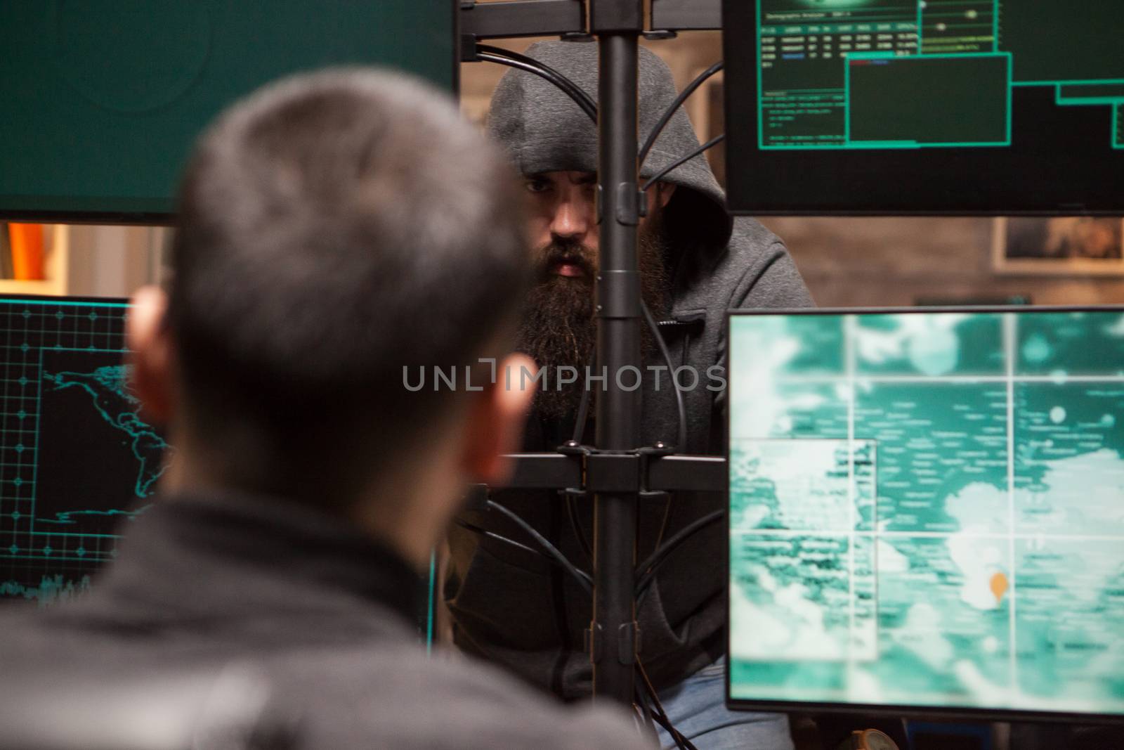 Cropped image of bearded hacker organise a cyber attack by DCStudio
