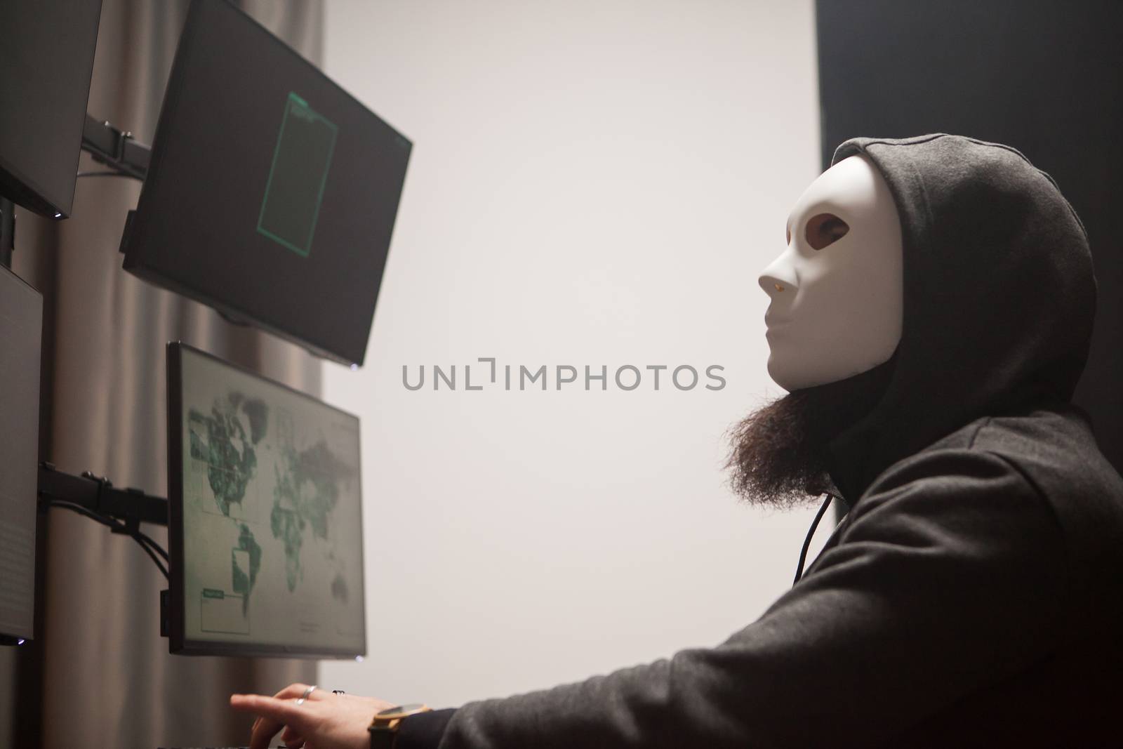 Side view of masked and dangerous hacker by DCStudio
