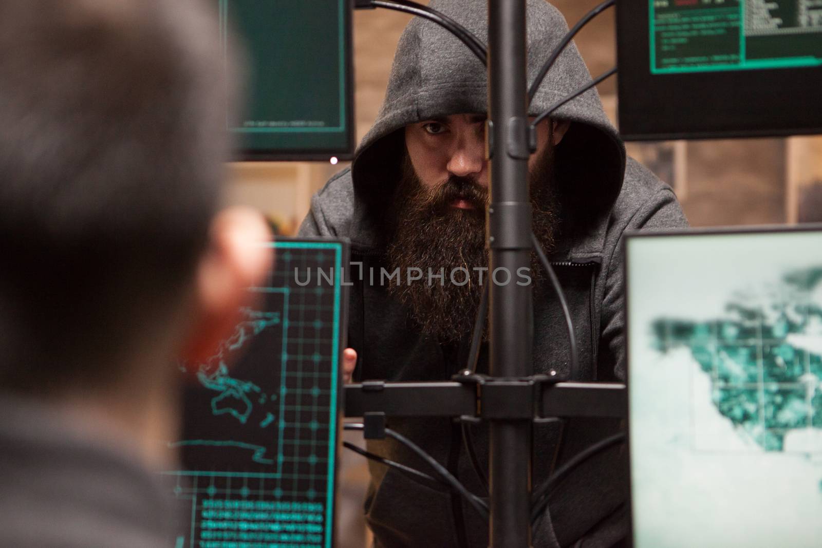 Shot of dangerous cyber criminals hacking credit cards by DCStudio