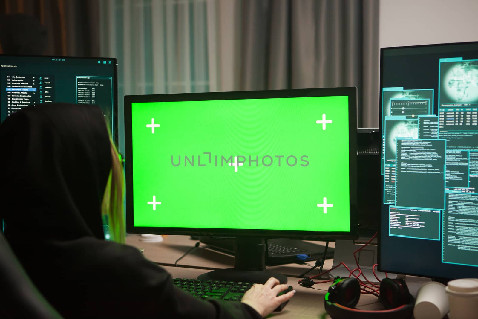 Wanted female hacker in front of computer with green screen by DCStudio