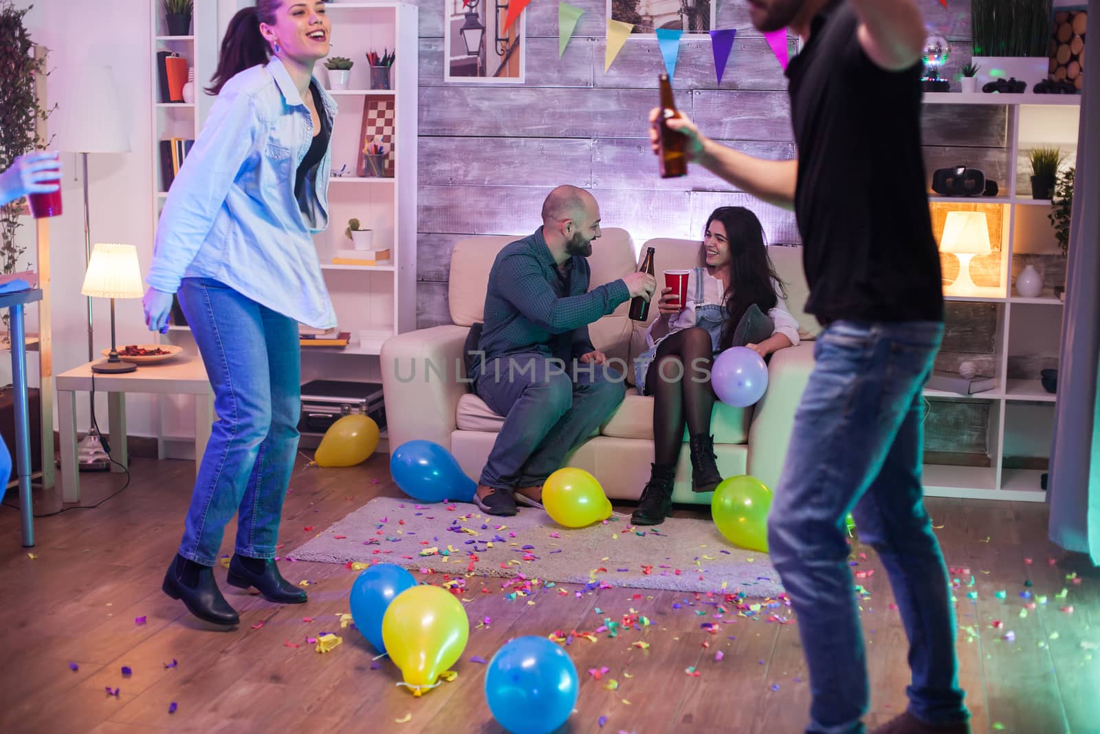 Beautiful young couple full of happiness at a party drinking alcohol.
