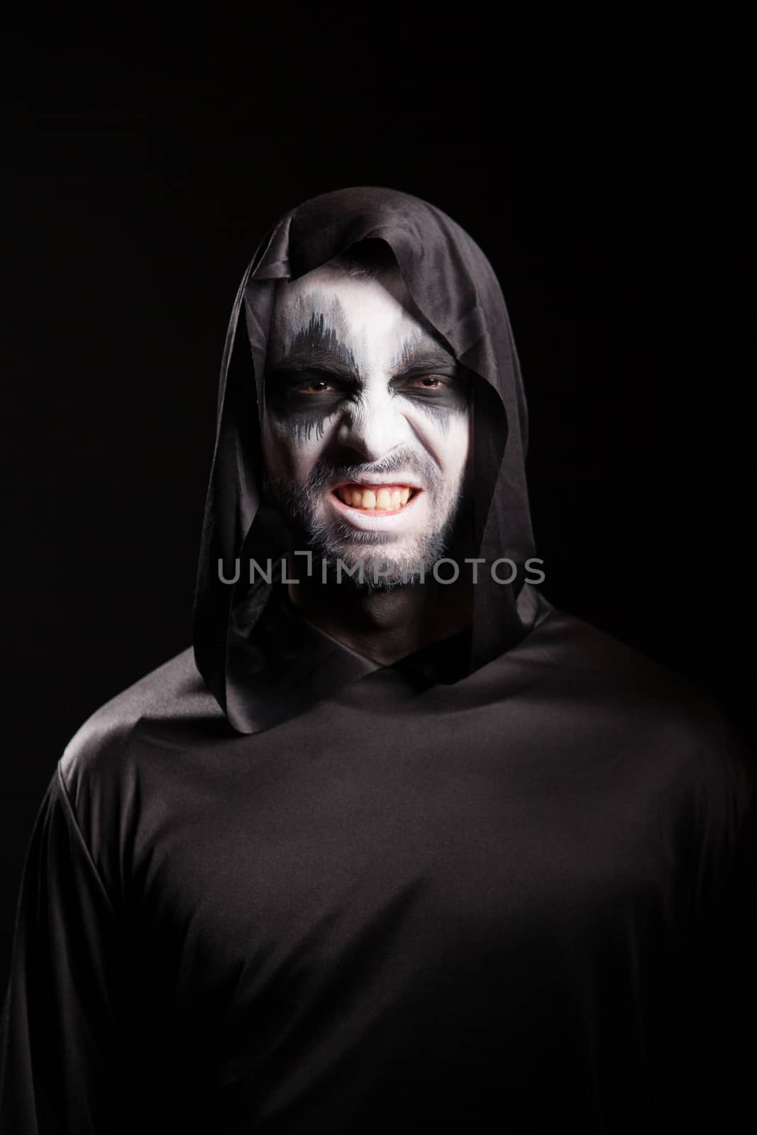 Grim reaper with a scary face isolated over black background by DCStudio