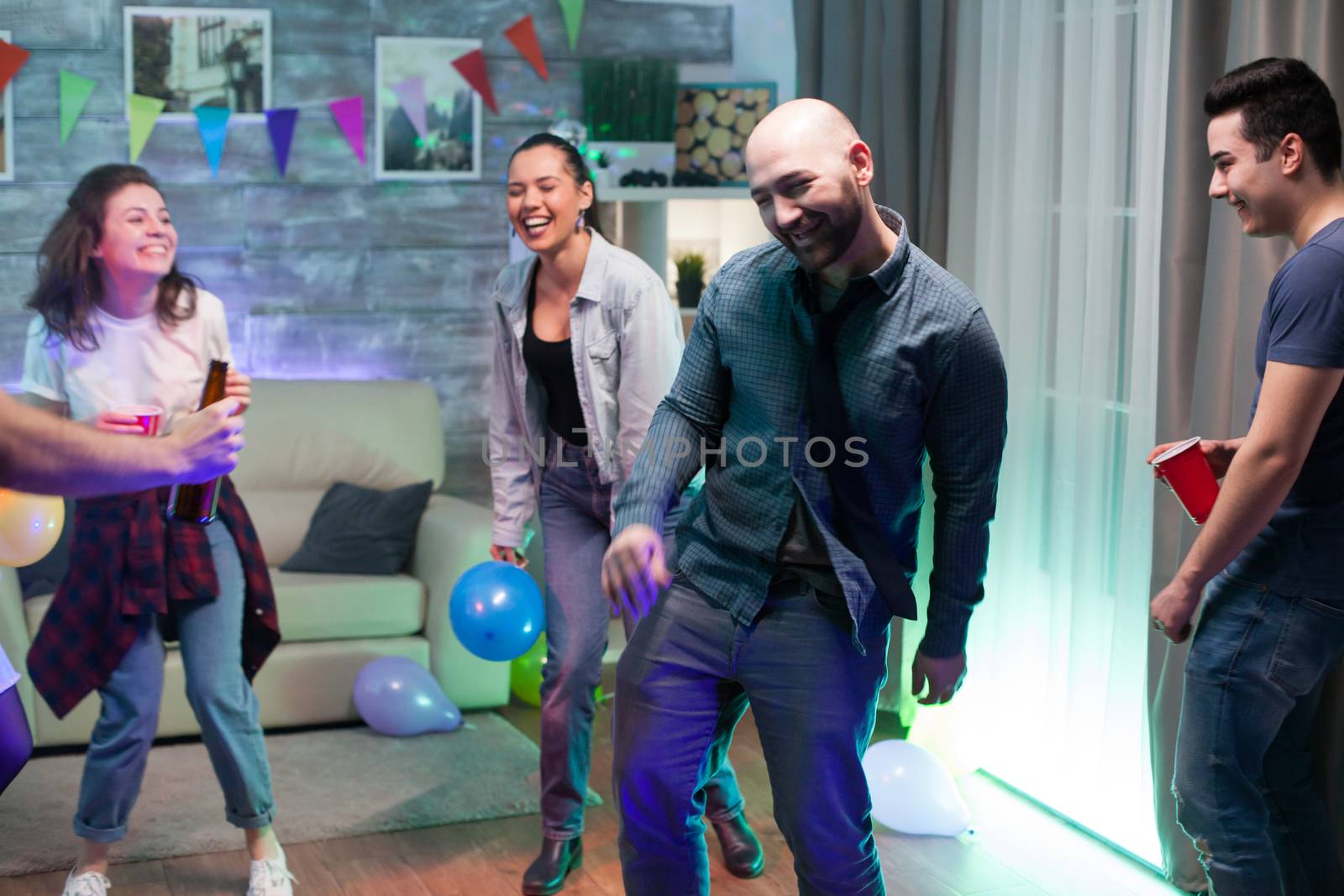 Cheerful man smiling after drinking too much alcohol at his friends party.