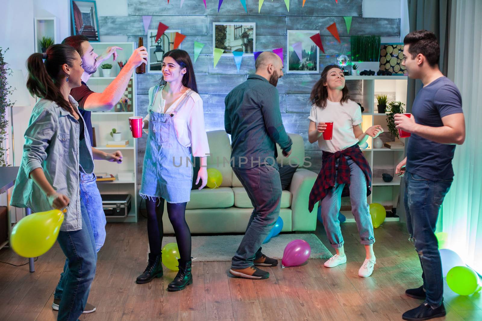 Young woman and her friends at a party. People enjoying good music.