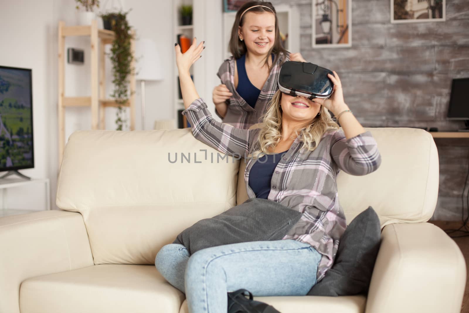 Young mother and her little girl excited about their new gadget. Virtual reality goggles.