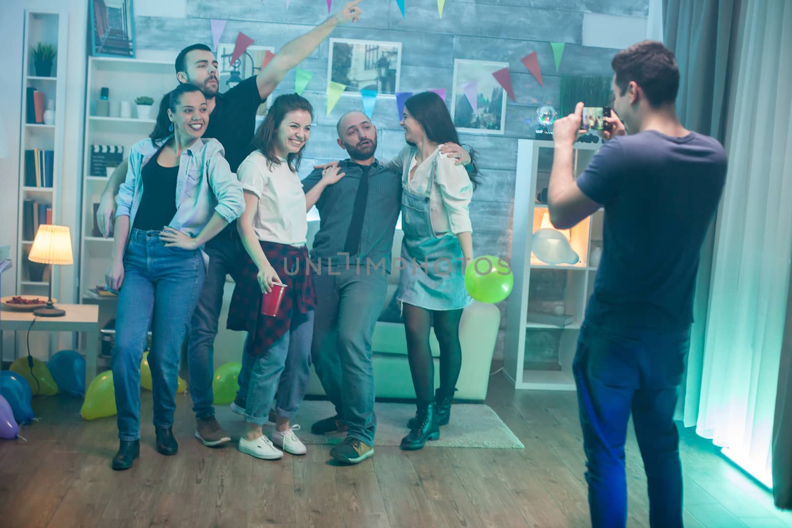 Group of young people enjoying themselves at a party celebrating friendship.