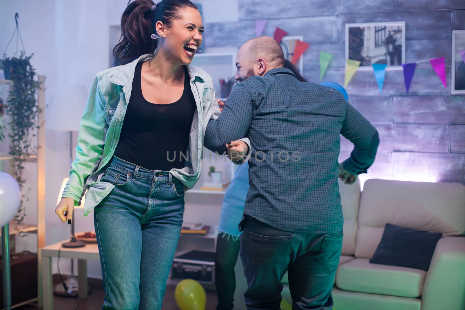 Beautiful young woman having fun with her friend at a party.