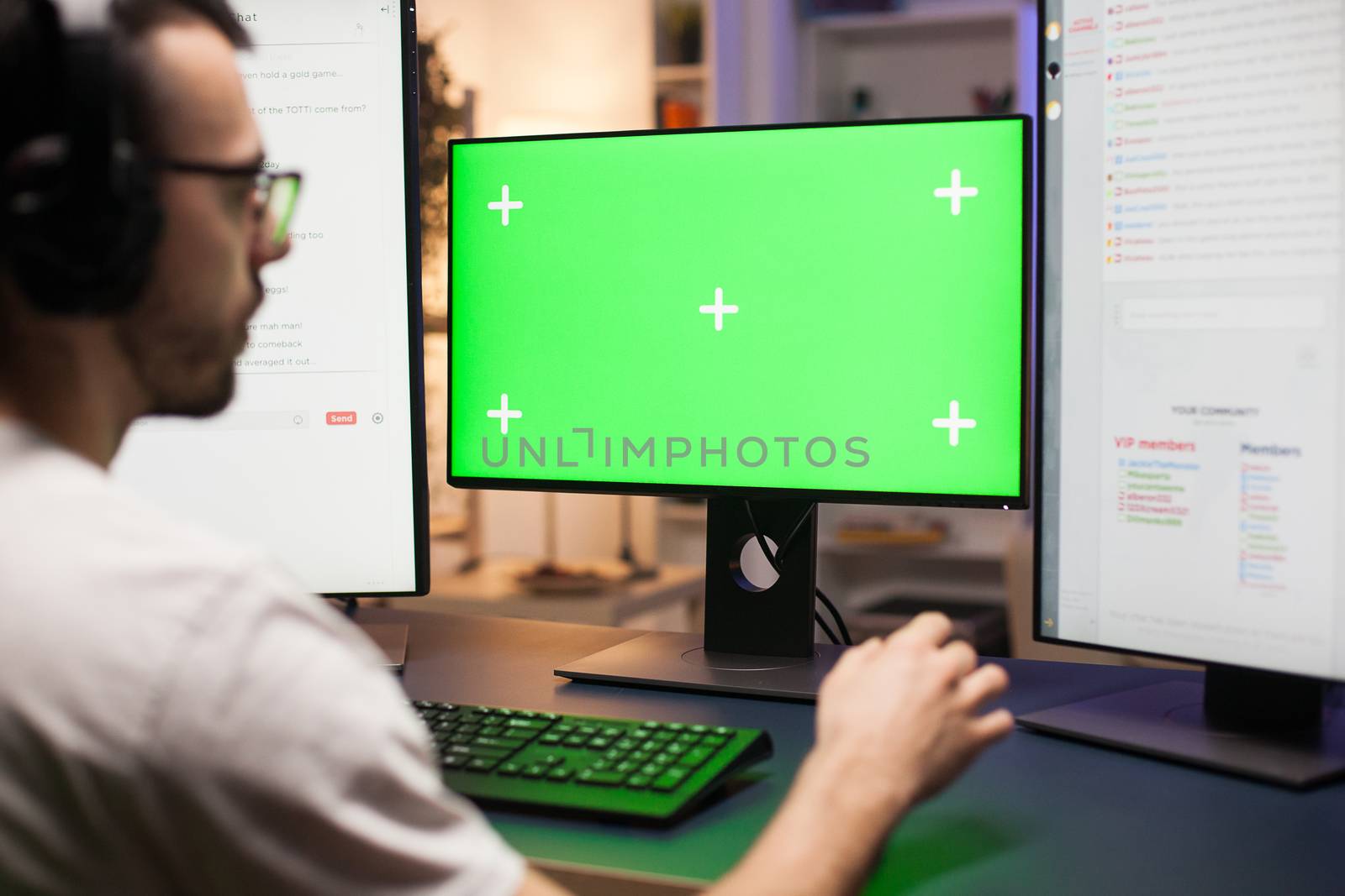 Young man with eyeglasses playing games on computer. by DCStudio