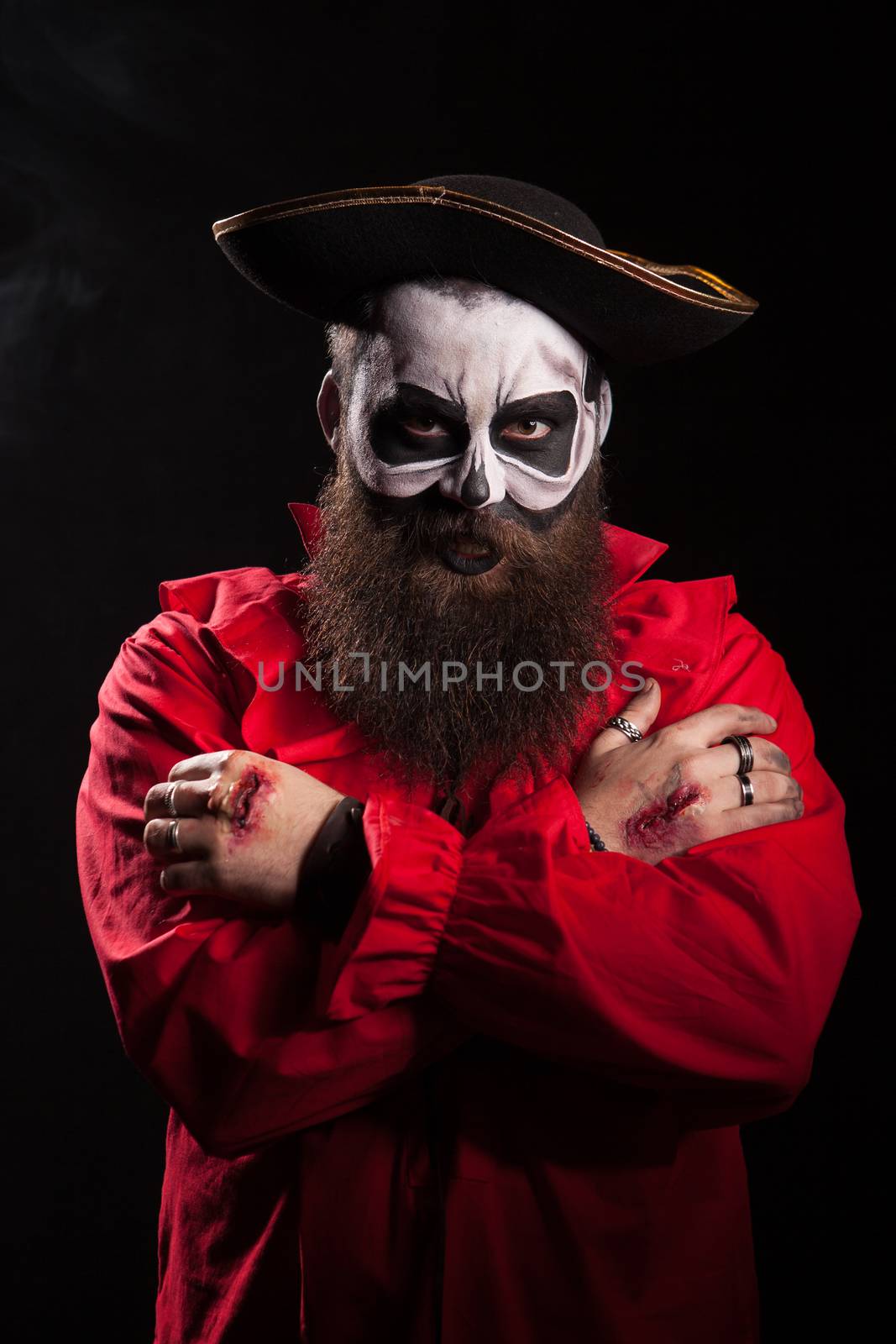 Male pirate with a spooky disguise over black background by DCStudio