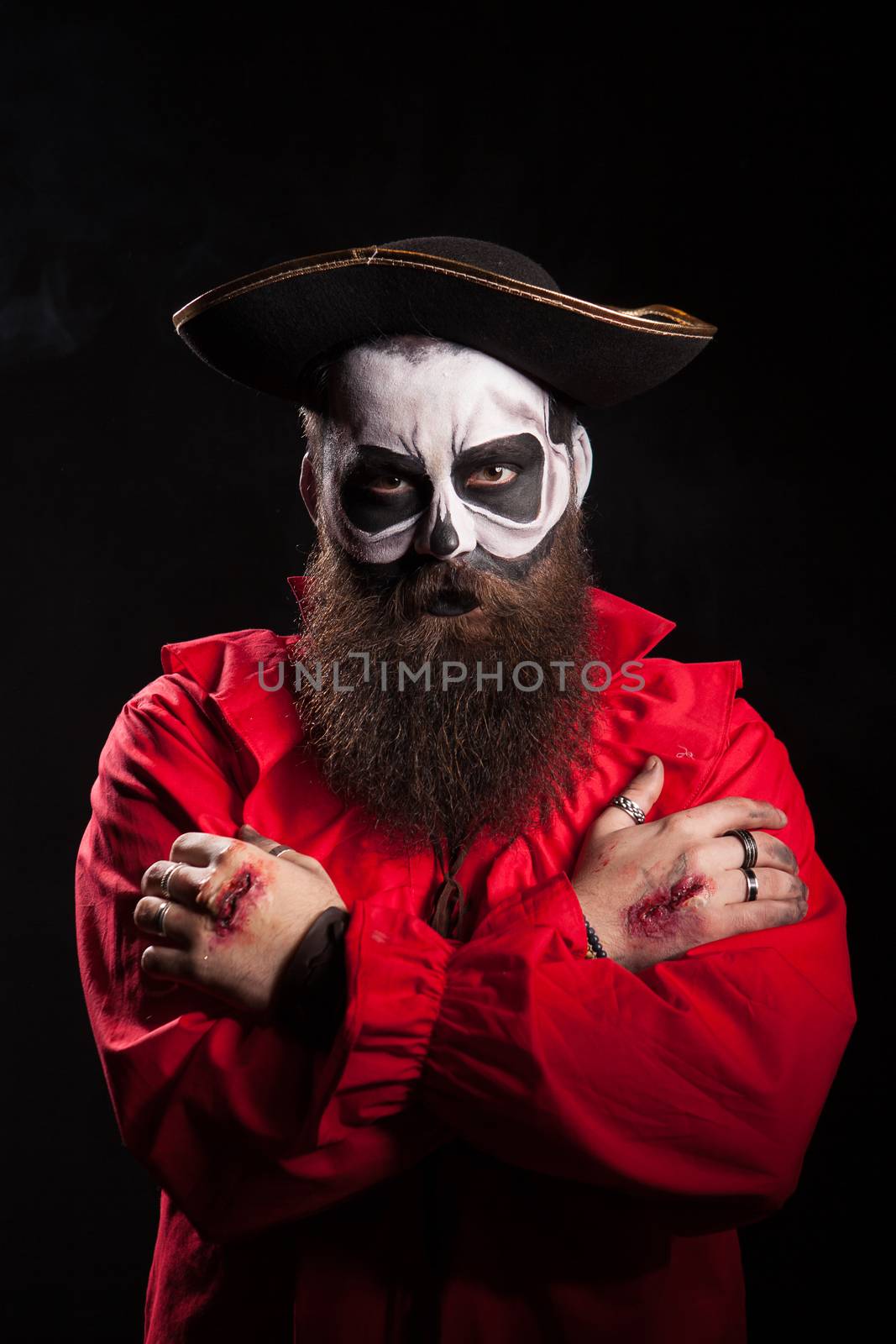 Scary bearded pirate with hands crossed over black background by DCStudio