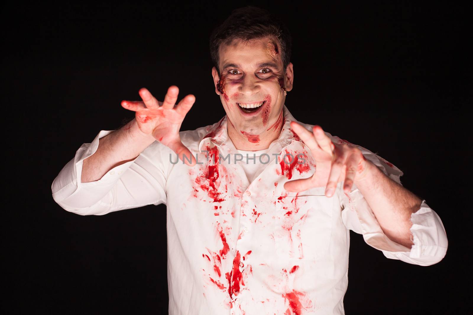 Man with a crazy horror make up over black background by DCStudio