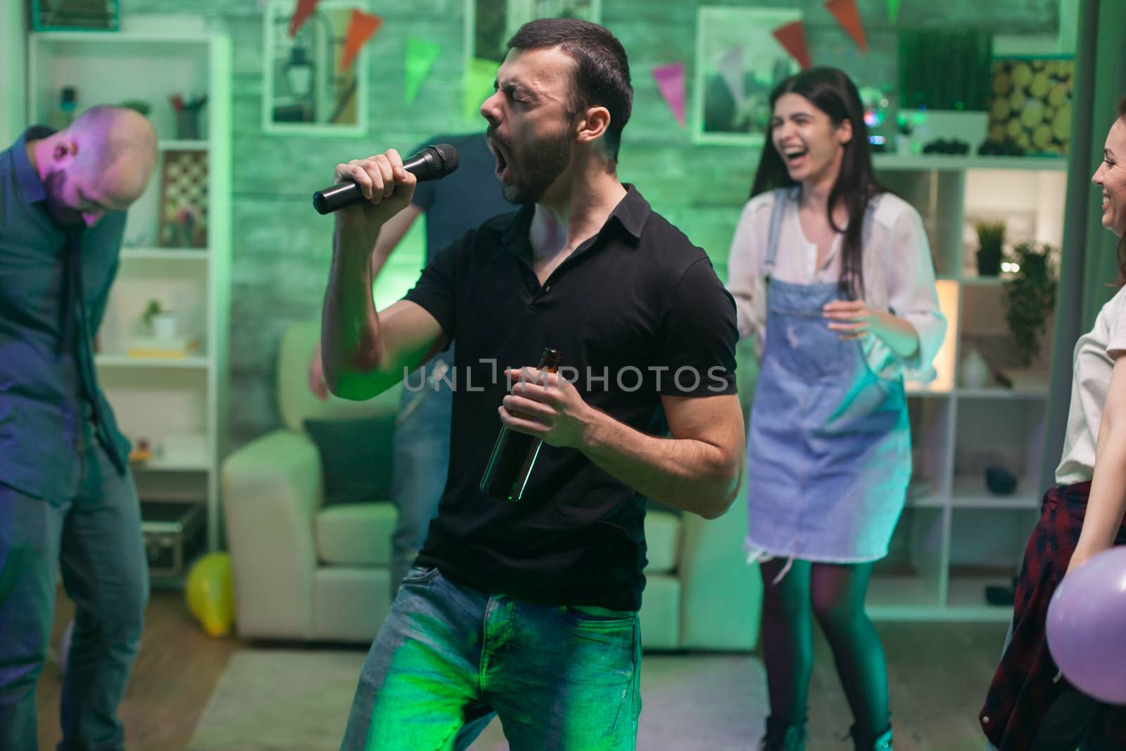 Bearded male singing a rock song on microphone by DCStudio