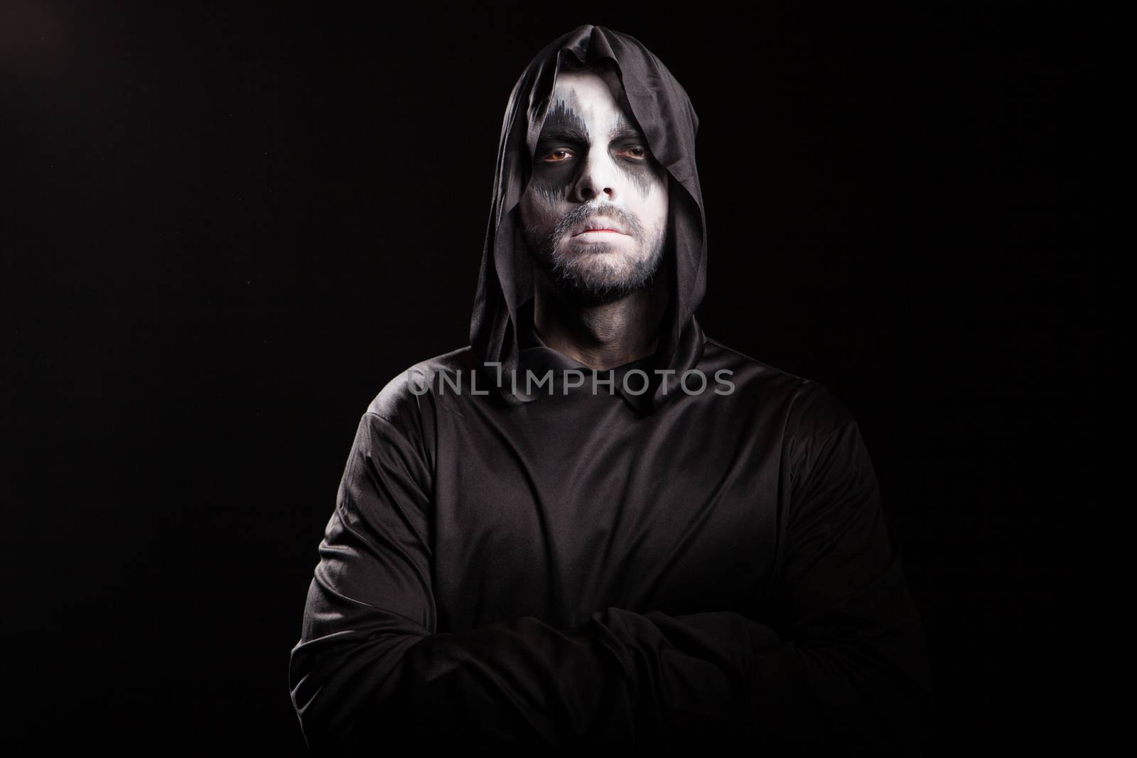 Thoughtful grim reaper over black background by DCStudio