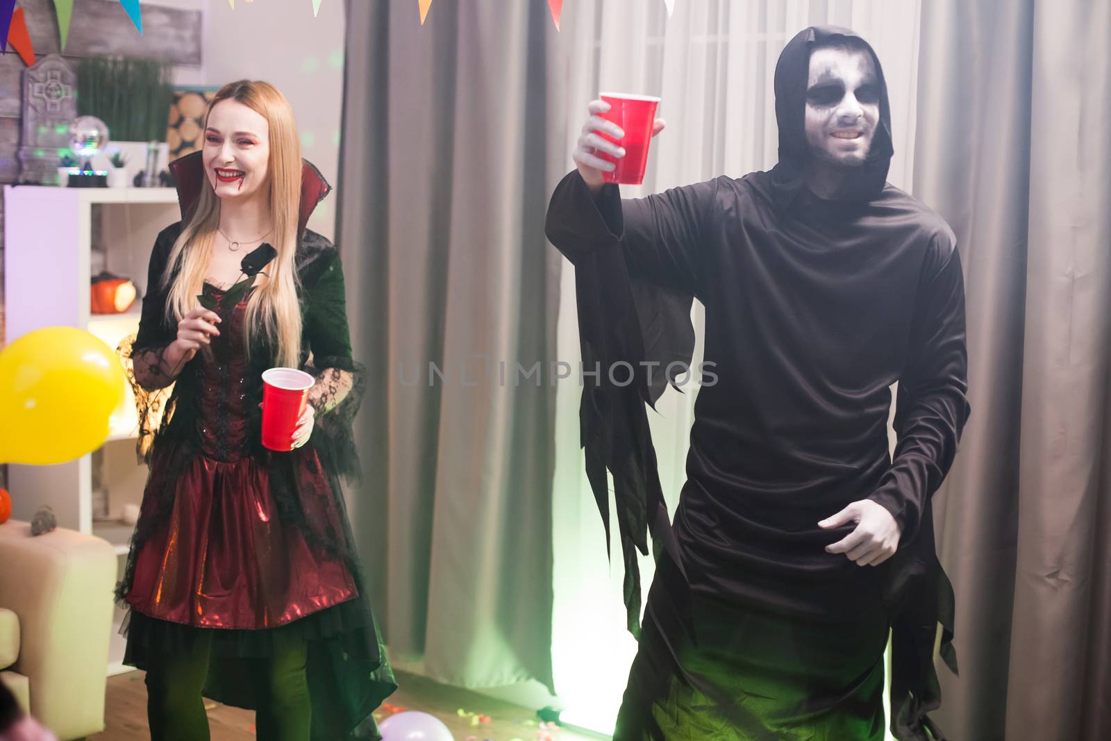 Man dressed up like a spooky grim reaper at a halloween by DCStudio