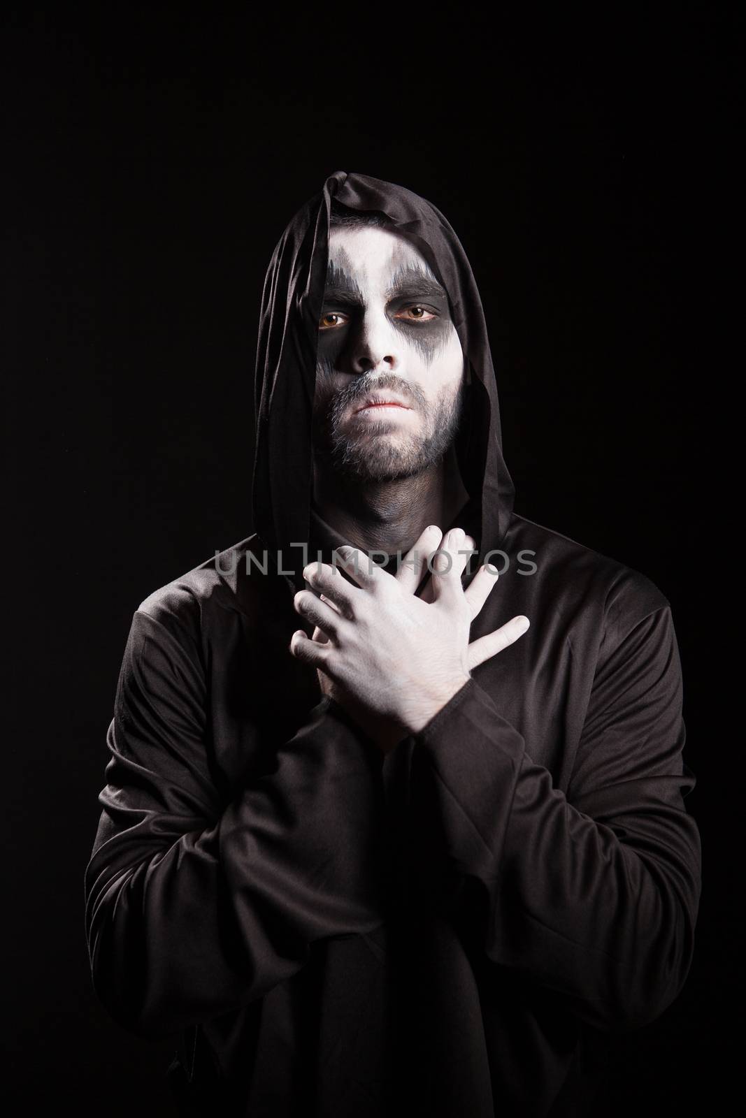 Thoughtful angel of death over black background. Halloween costume.