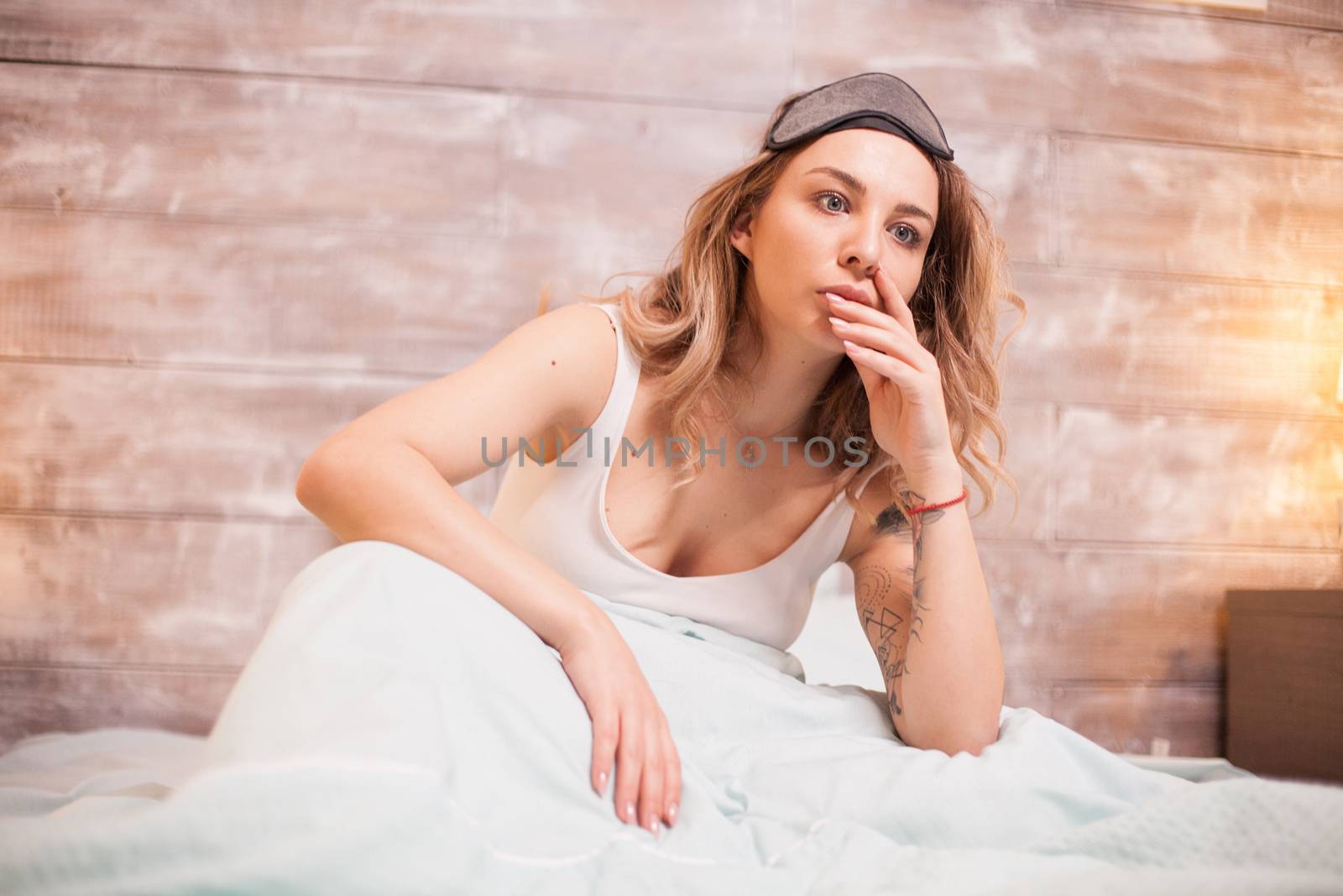 Beautiful young woman in bedroom suffering of insomnia.