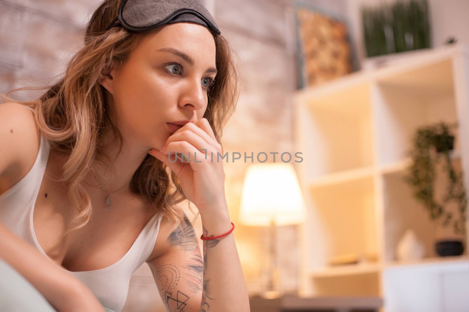 Young woman in her apartment at night can't sleep by DCStudio