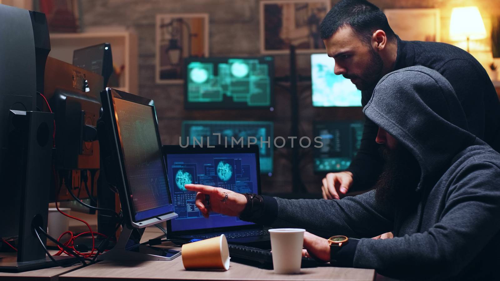 Team of cyber criminals using modern software by DCStudio