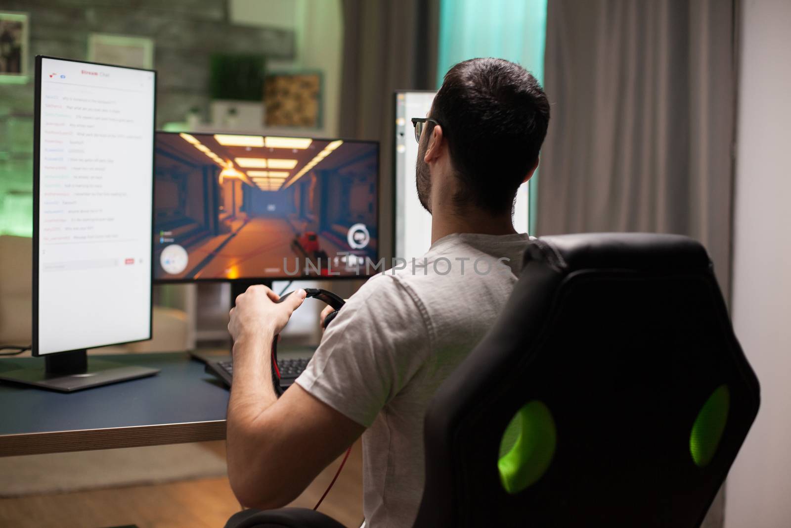 Man playing shooter games while streaming by DCStudio