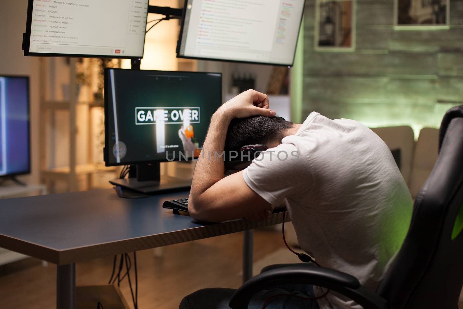 Young man upset after losing at shooter game by DCStudio