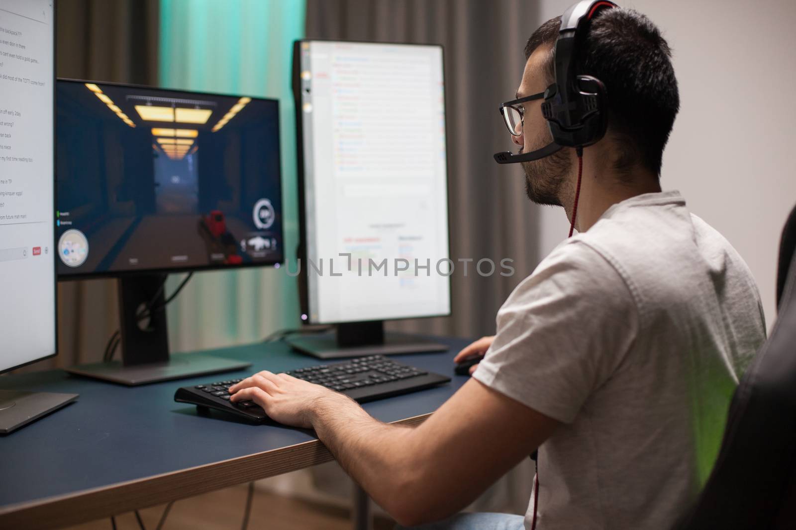 Bearded man having fun while playing shooter games by DCStudio