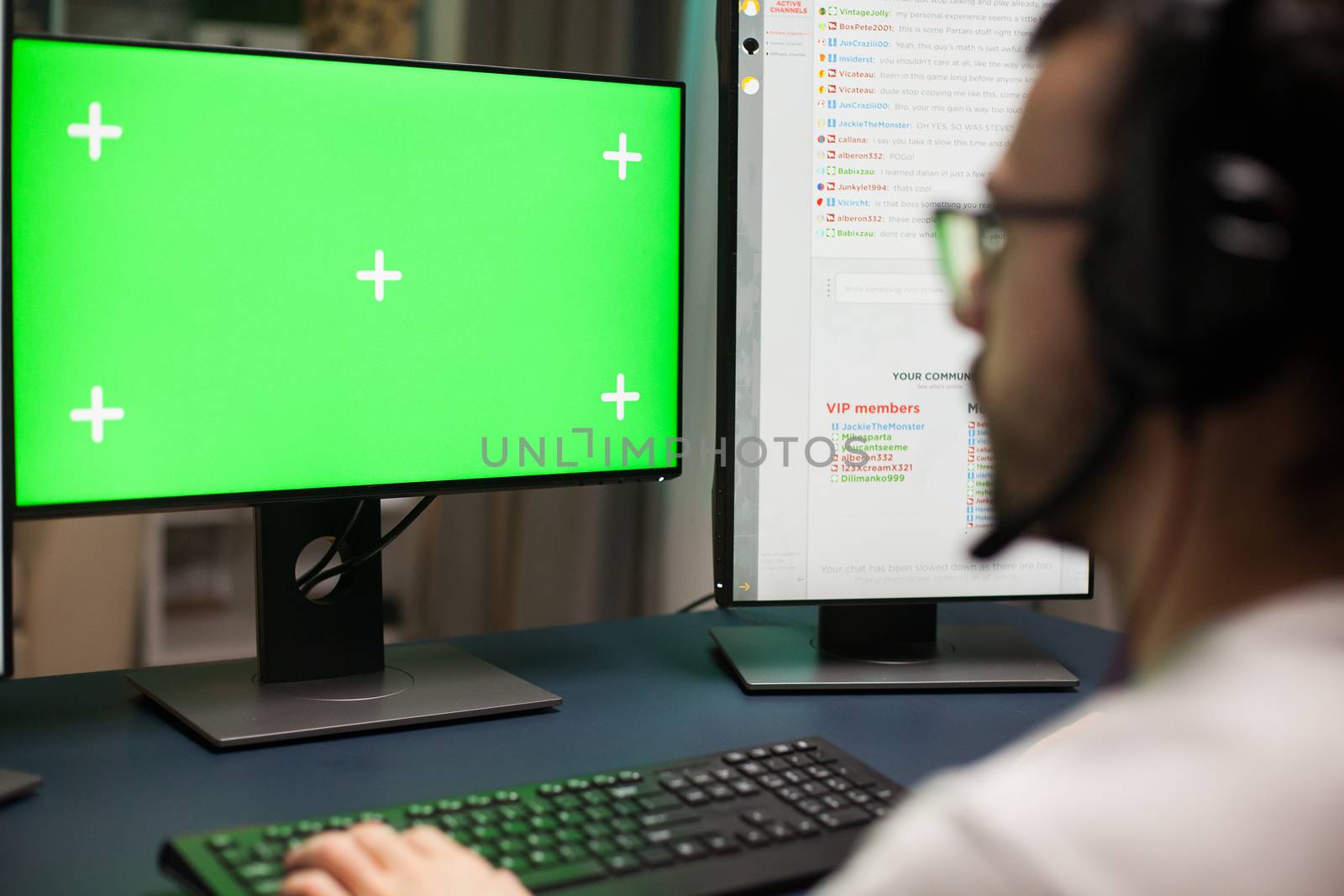 Close up young man playing games on computer with green screen.