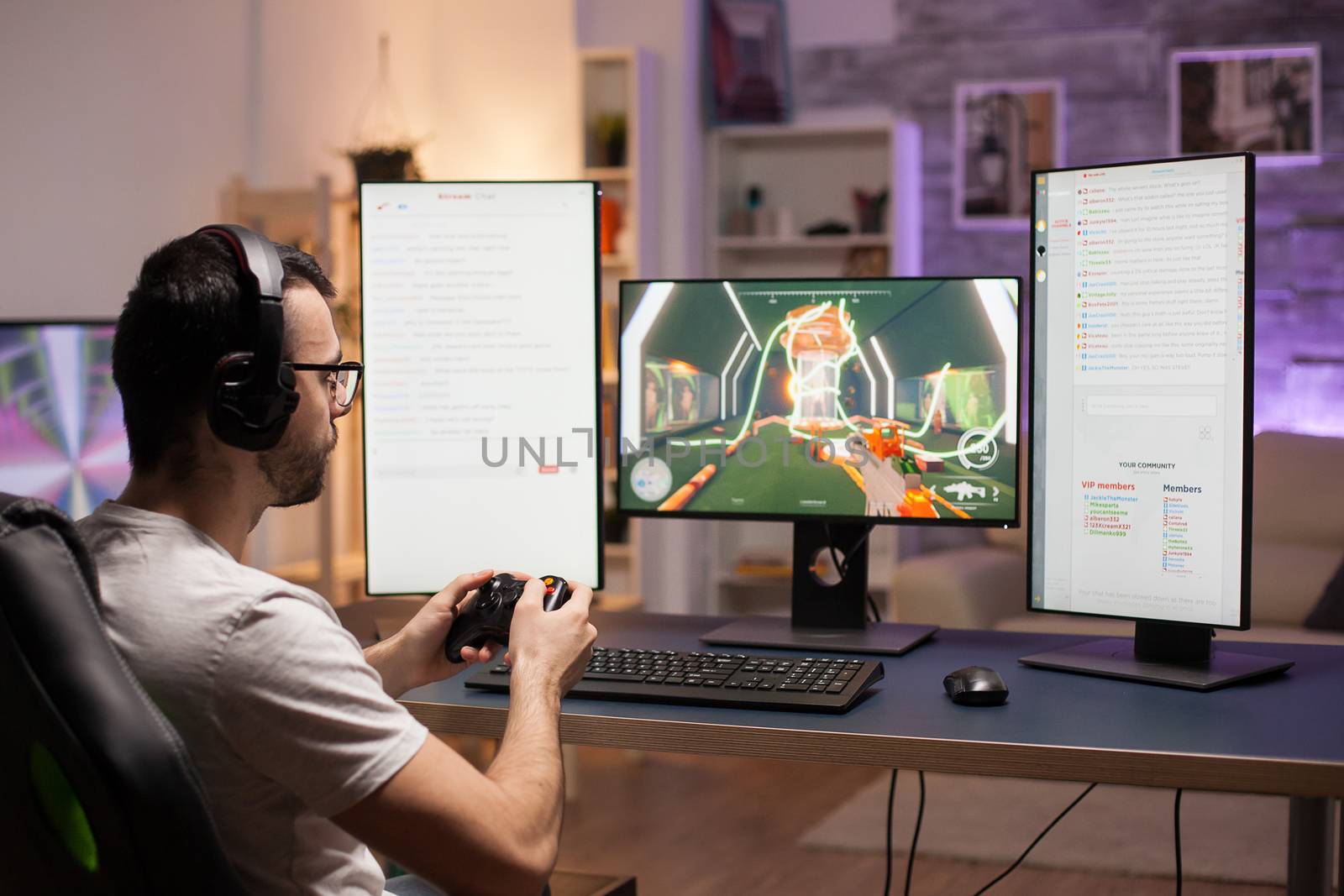 Young man with eyeglasses playing shooter games at home using wireless controller.