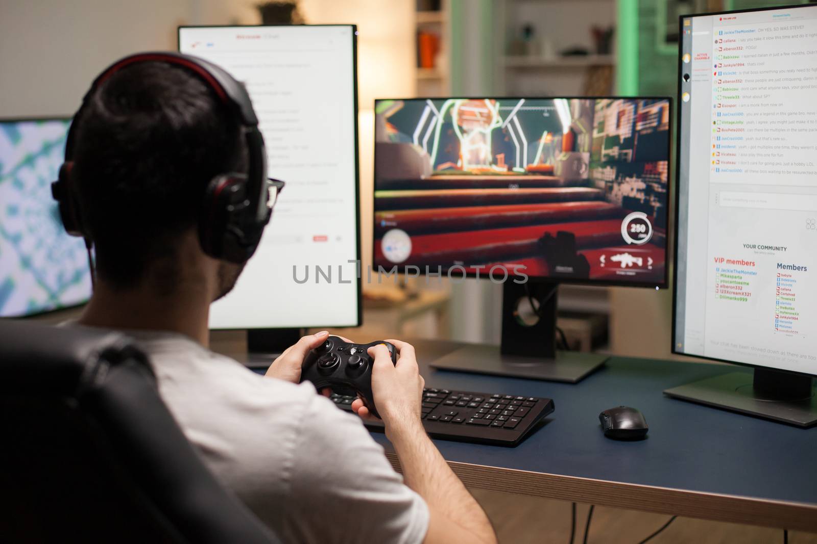 Back shot of young playing online shooter video games on computer by DCStudio