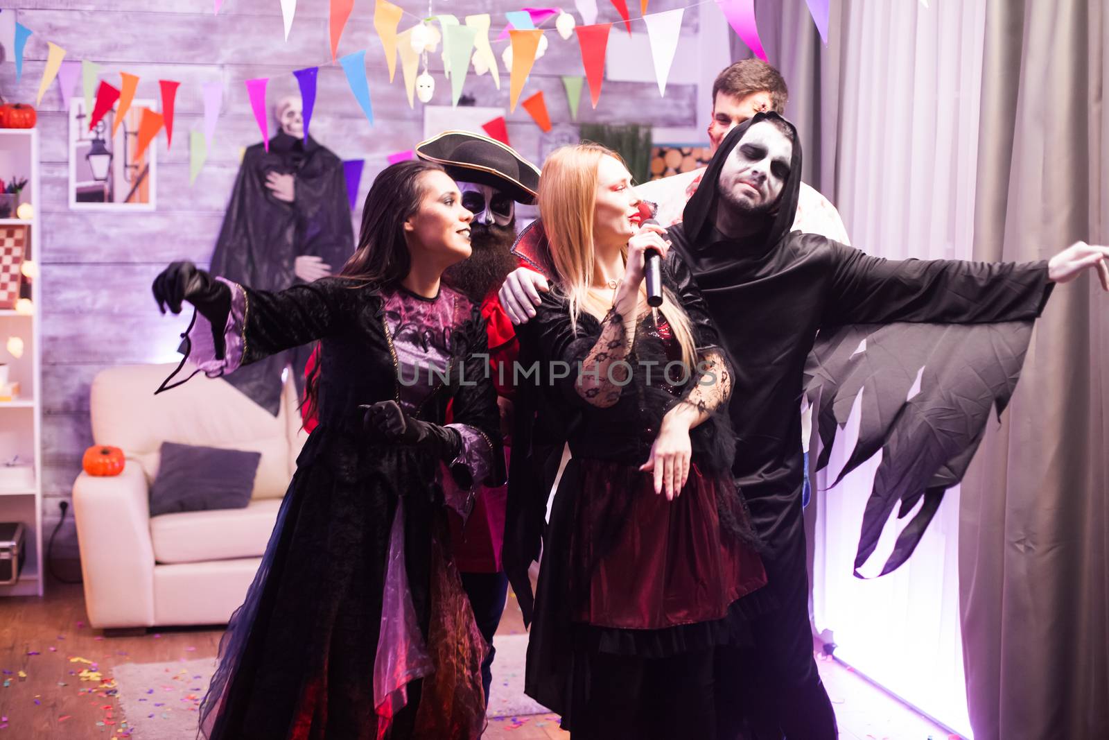 Attractive vampire woman singing at a halloween party by DCStudio