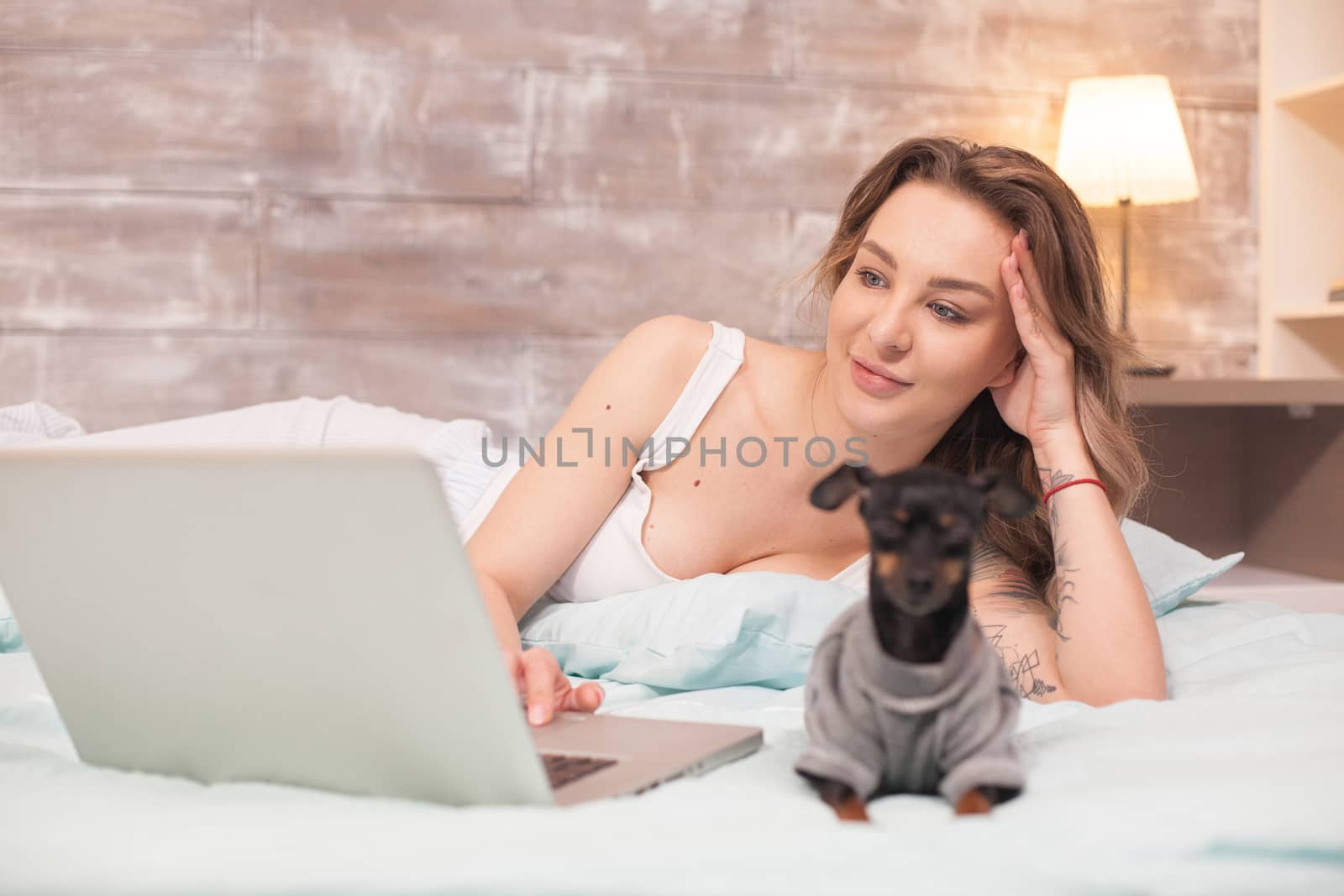 Caucasian woman in pajamas in her bed at night by DCStudio