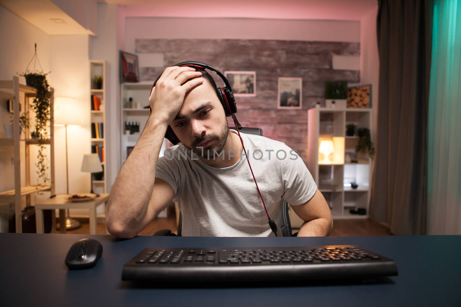 Pov of young man can't believe it's game over for him while playing online shooter games.