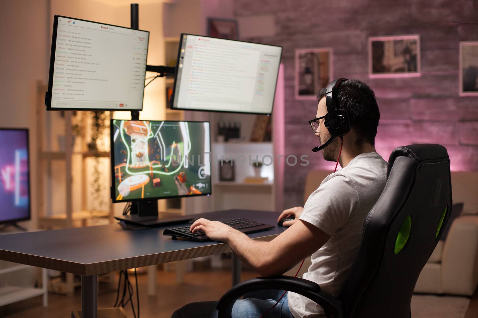 Man wearing headphones in a room with neon light by DCStudio