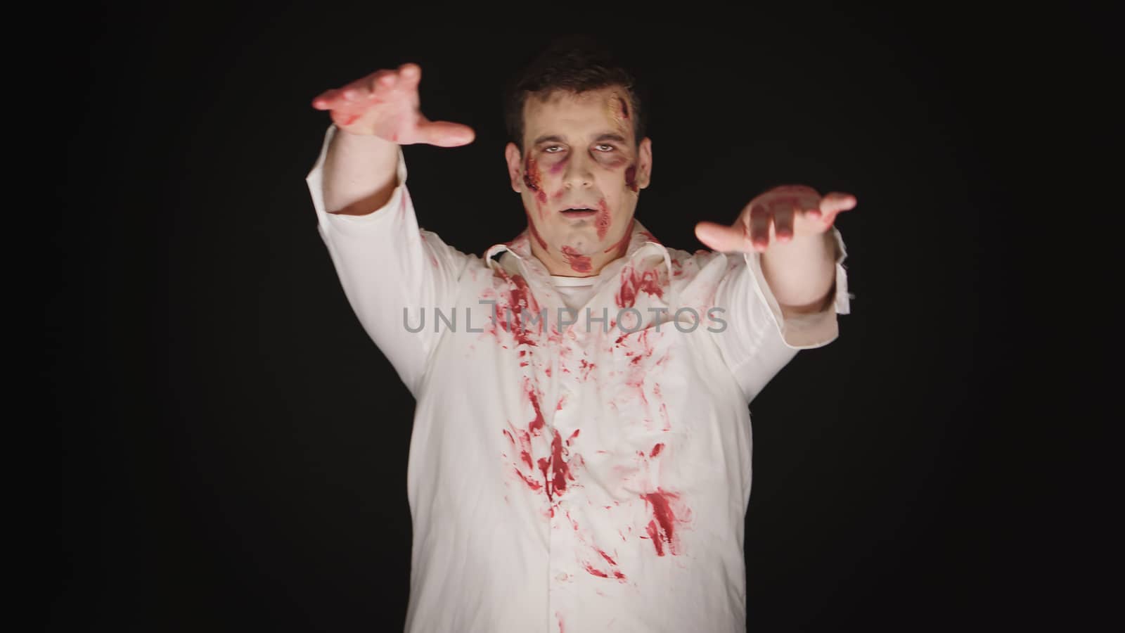 Caucasian young man dressed up like zombie for halloween.
