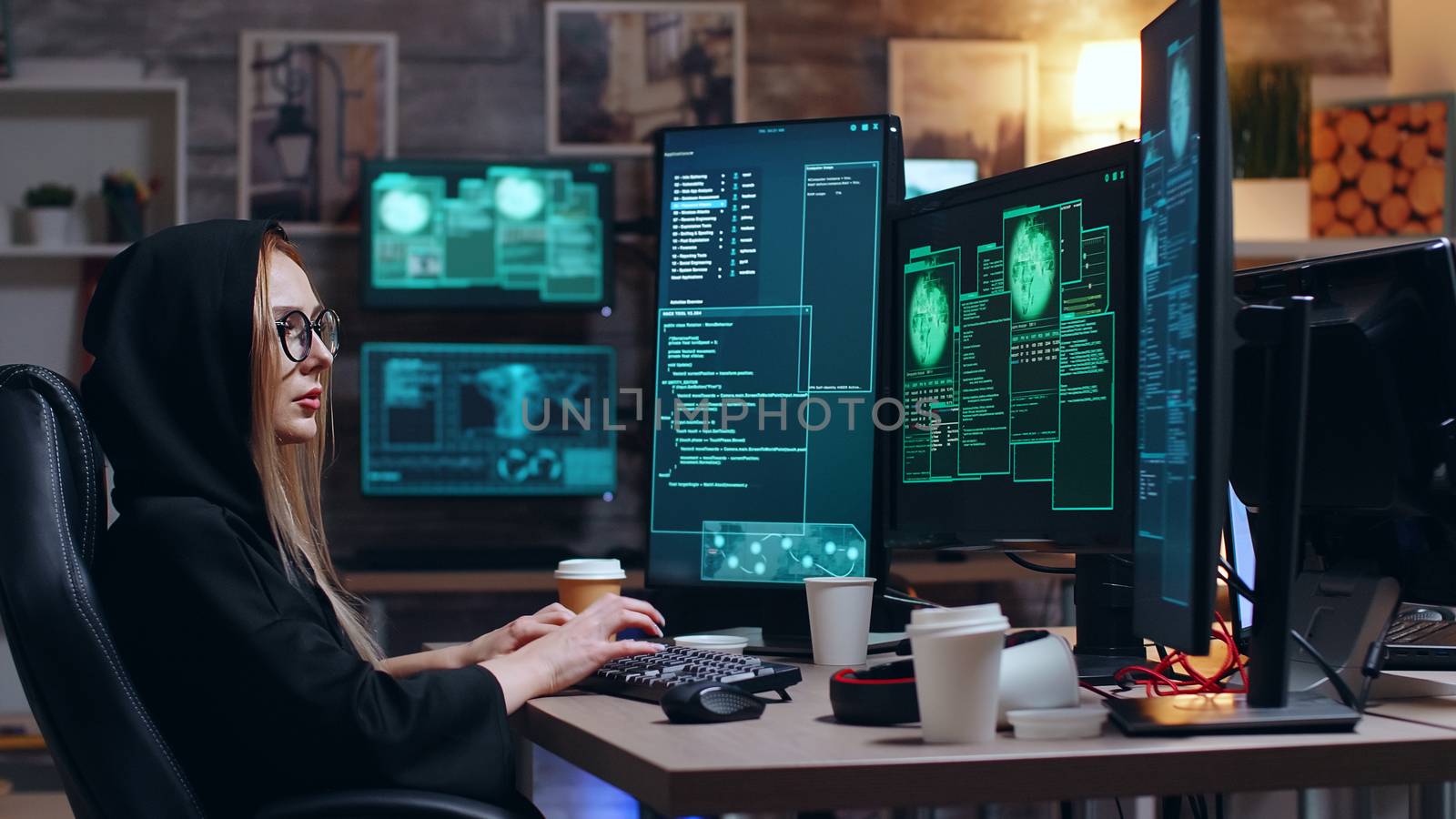 Female hacker wearing a hoodie using a dangerous virus by DCStudio
