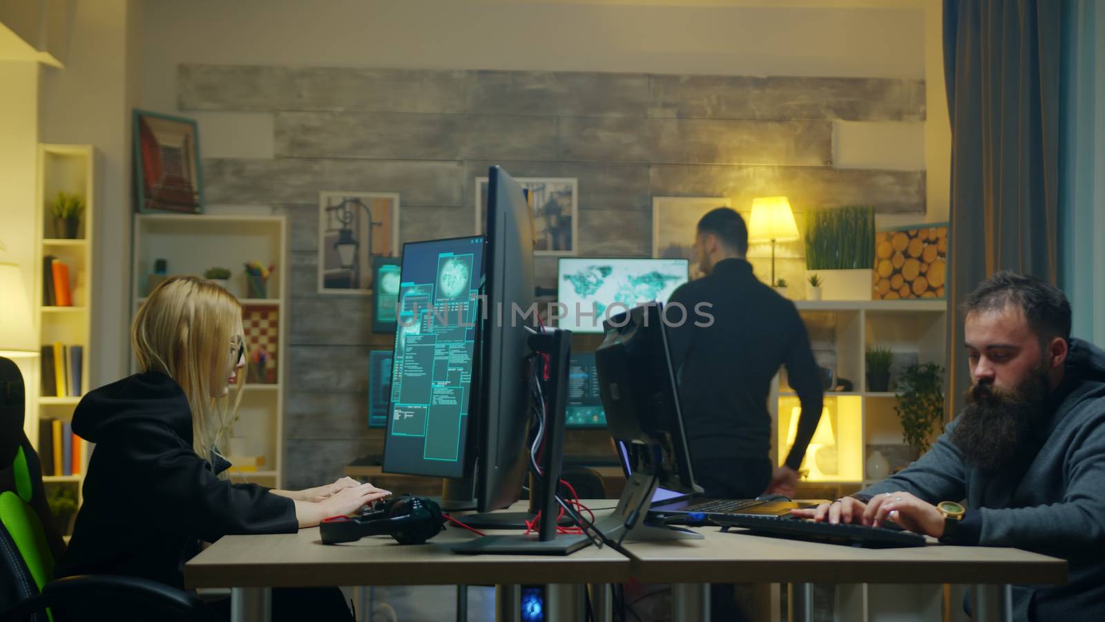 Hacker girl with her team stealing online information using super computers.