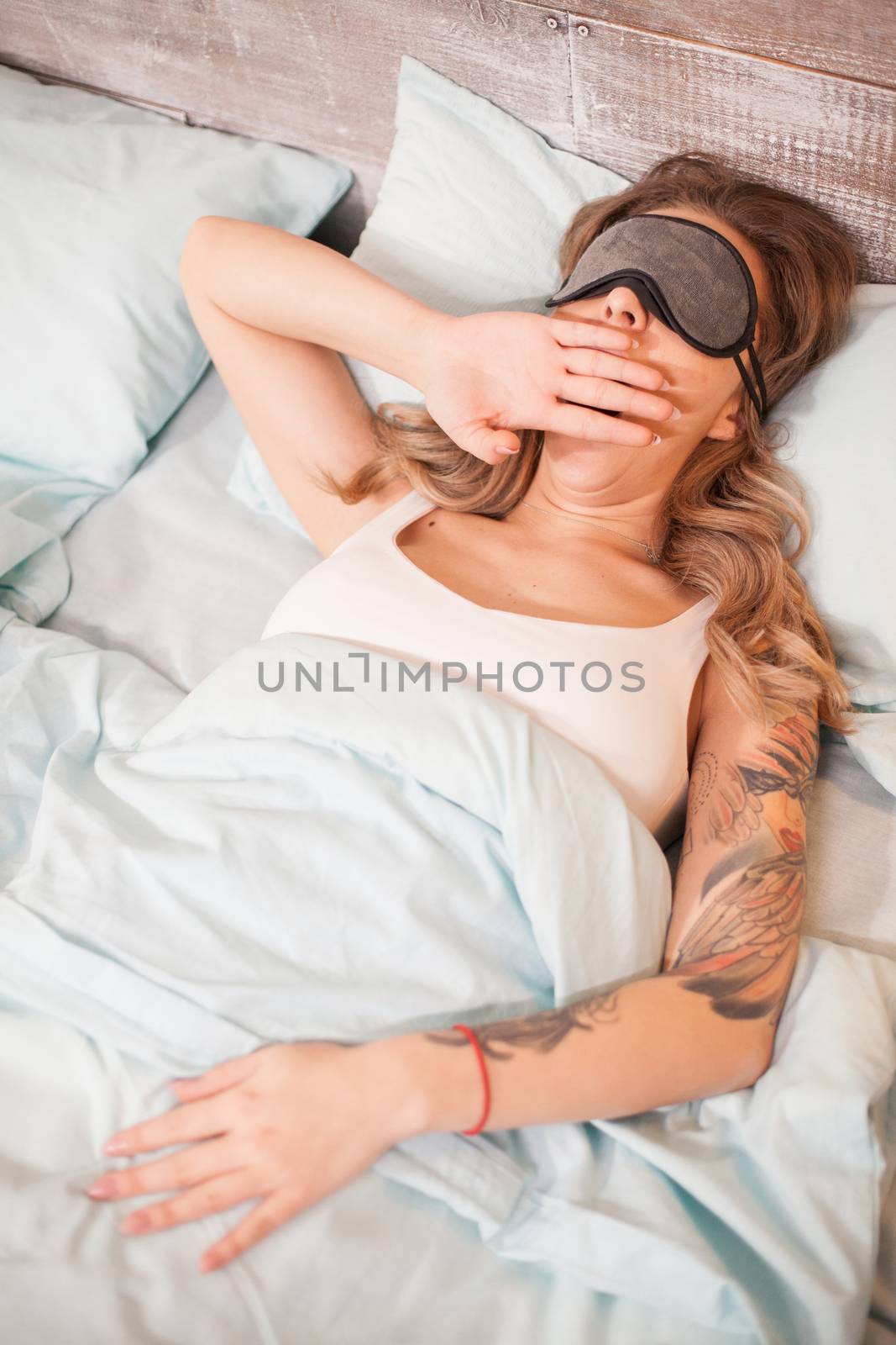 Top view of beautiful at night sleeping with cover eye mask by DCStudio