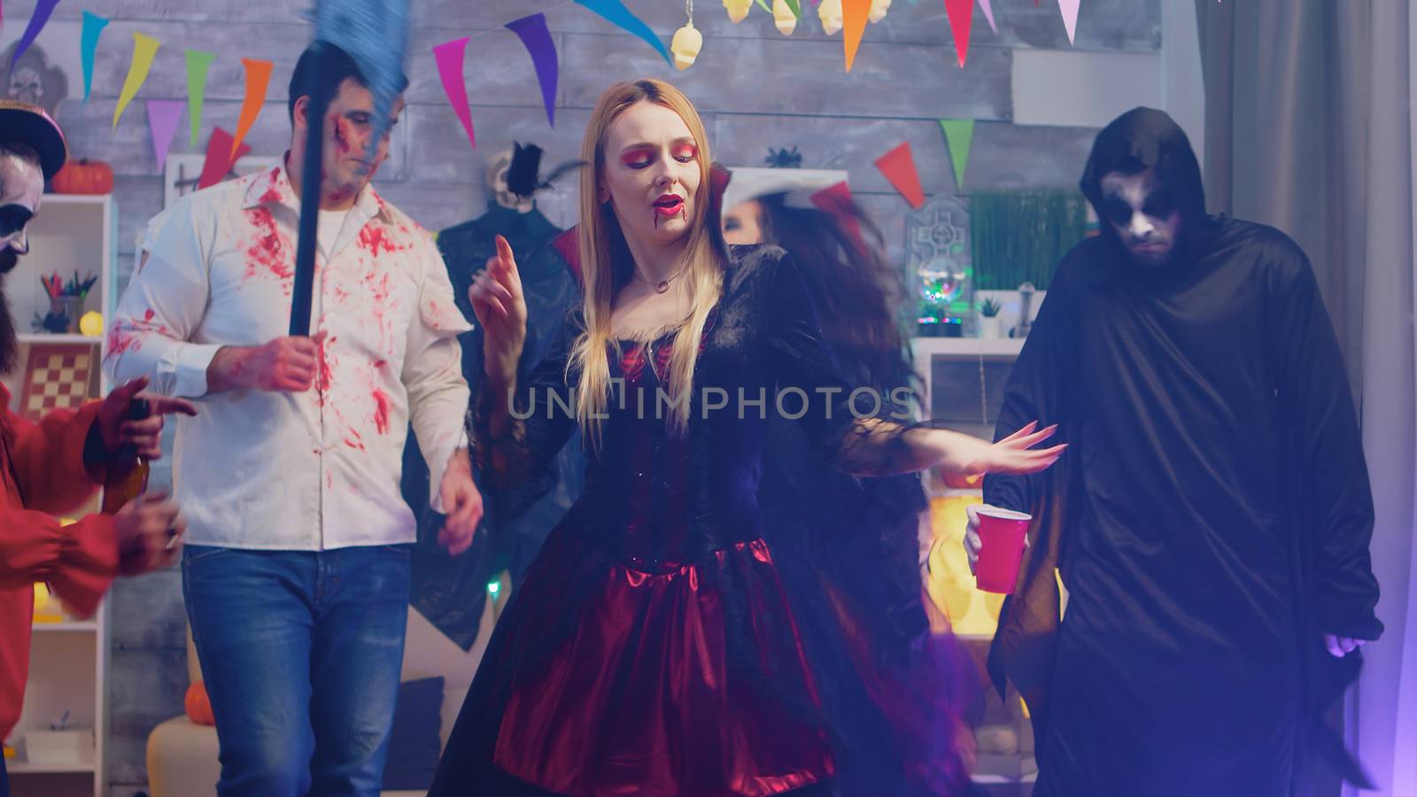Evil beautiful enchantress dancing at halloween party by DCStudio