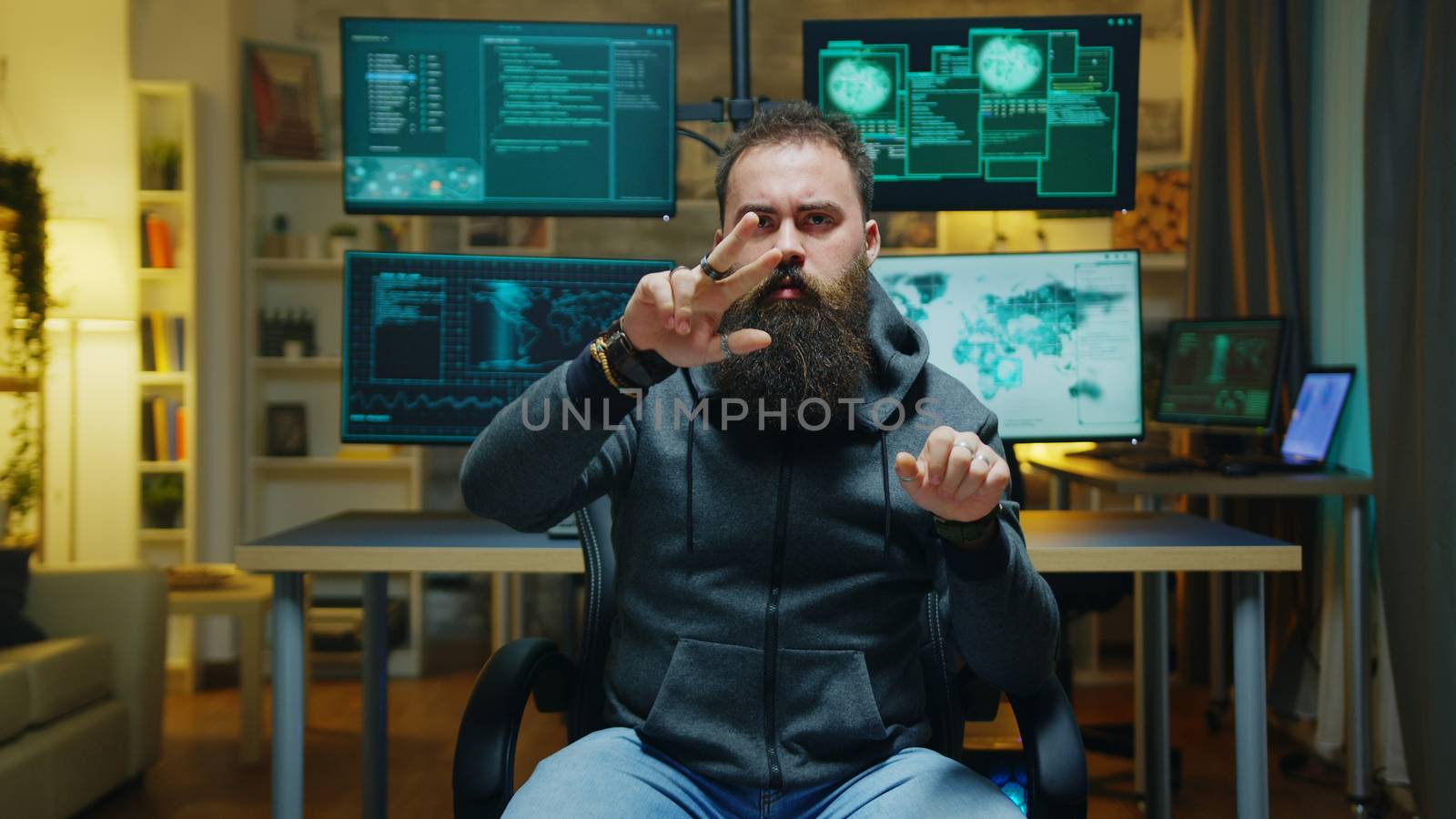 Bearded hacker doing hand gestures using augmented reality while breaking a firewall.