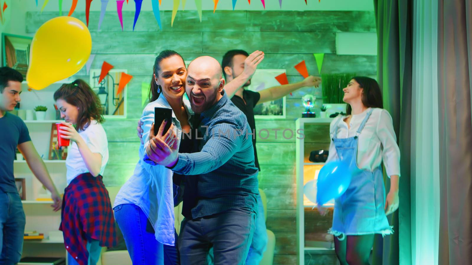 Cheerful bald man taking a selfie with his attractive friend by DCStudio