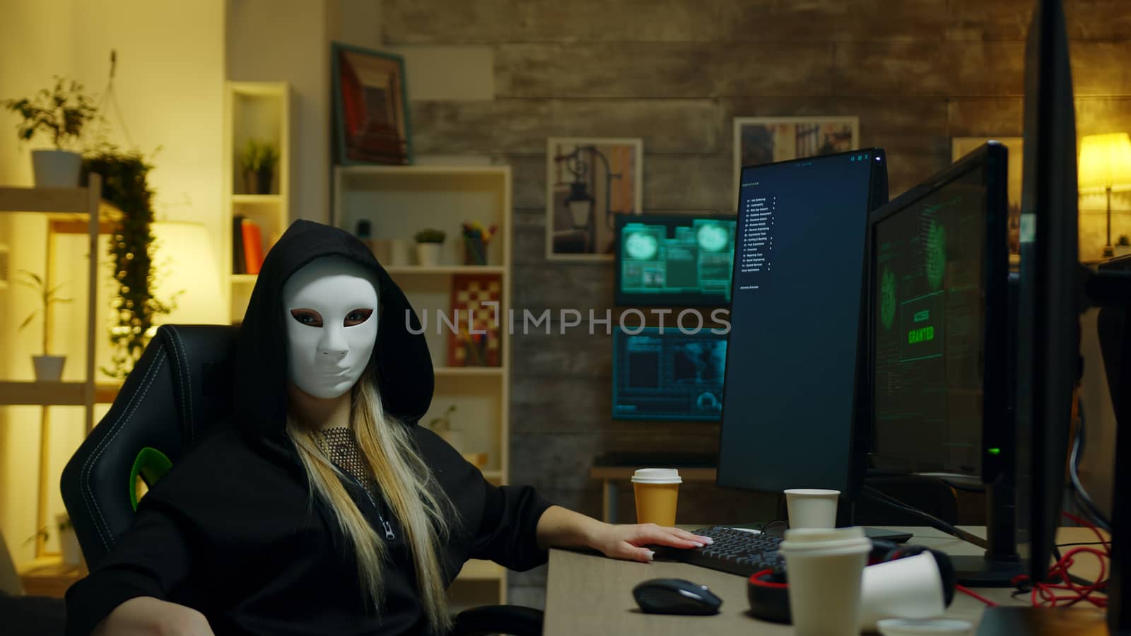 Hacker girl wearing a white mask while doing cyber crimes by DCStudio