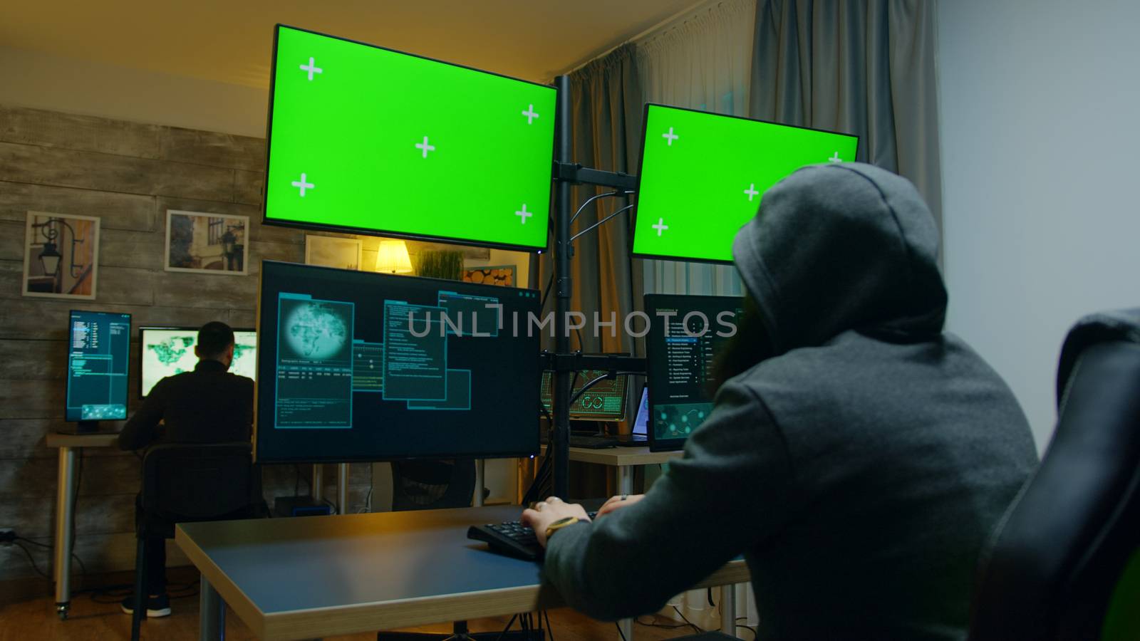 Hacker with a hoodies making a dangerous malware by DCStudio