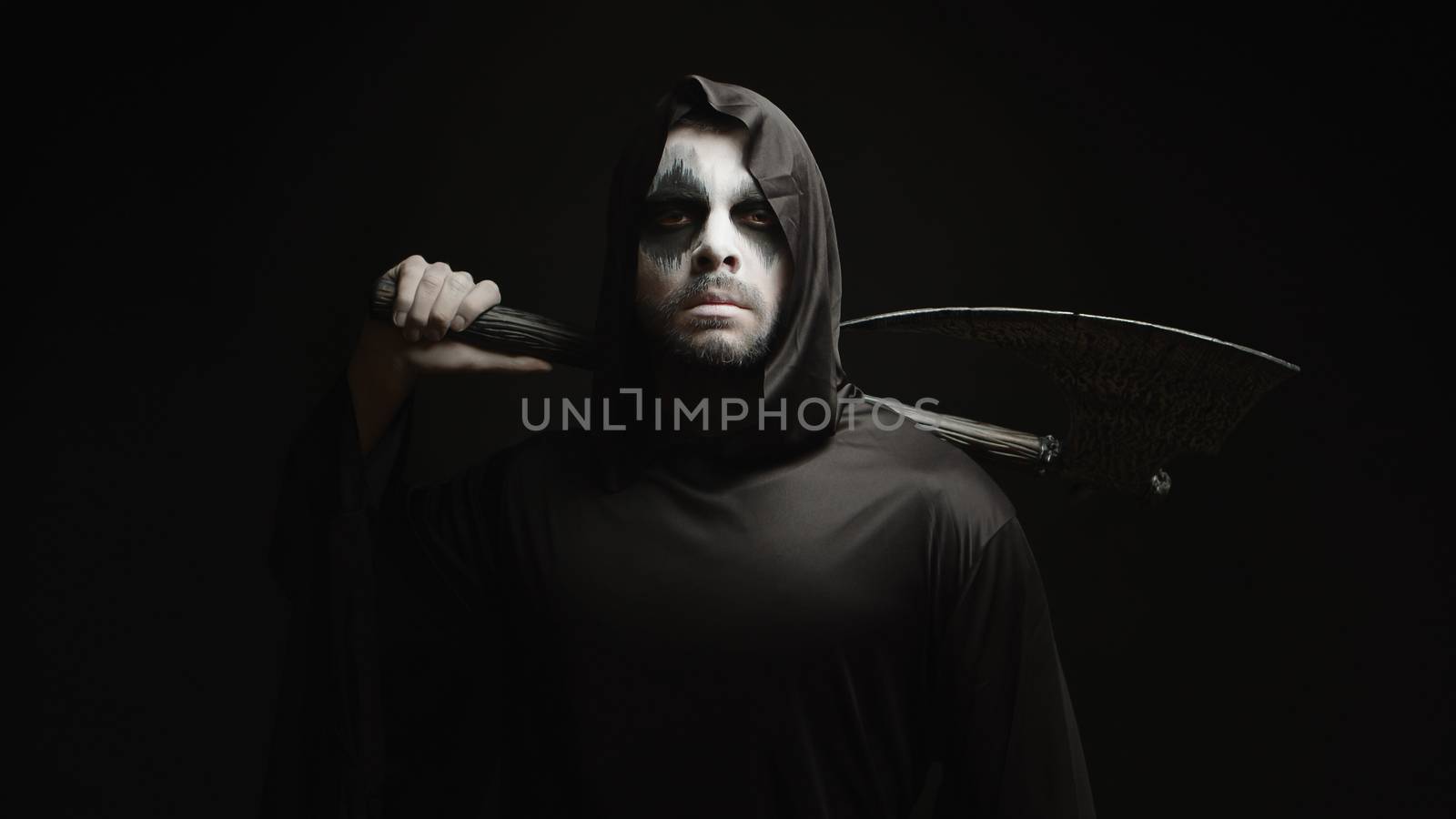 Grim reaper over black background with axe in his hands by DCStudio