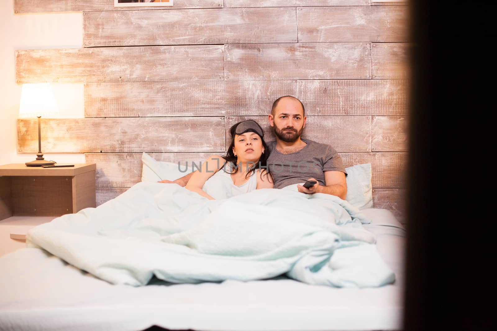 Caucasian husband and wife wearing pajamas by DCStudio
