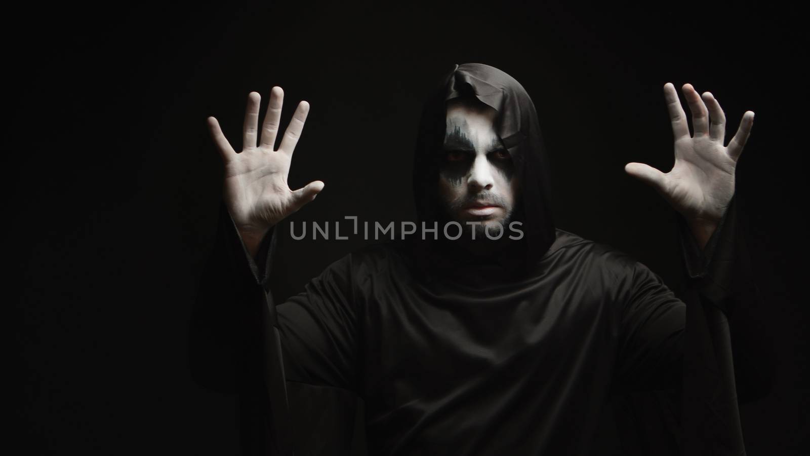 Young man with scary make up dressed up like grim reaper by DCStudio